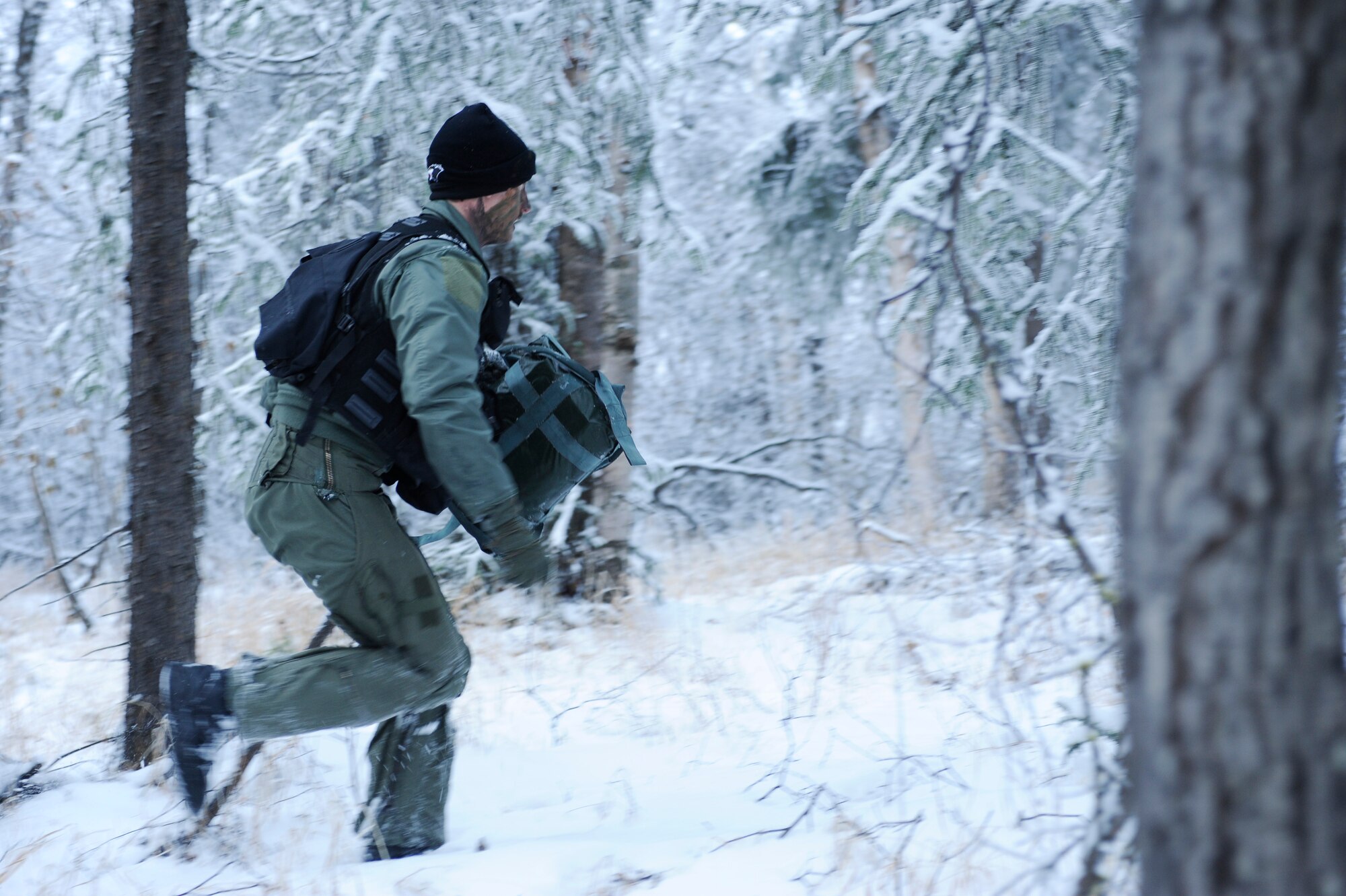1st Lt. Matthew Feeman, 80th Fighter Squadron, Kunsan Air Base, Korea runs through the woods to escape from enemy forces not too far behind as he navigates through the woods to a safe location to get extracted during RED FLAG-Alaska 09-1 Oct. 14, 2008, at Eielson Air Force Base, Alaska. Lieutenant Feeman is playing the role of a pilot who was shot down behind enemy lines and he must now survive, evade, resist and escape to successfully complete the training mission.  (U.S. Air Force photo/Senior Airman Jonathan Snyder)