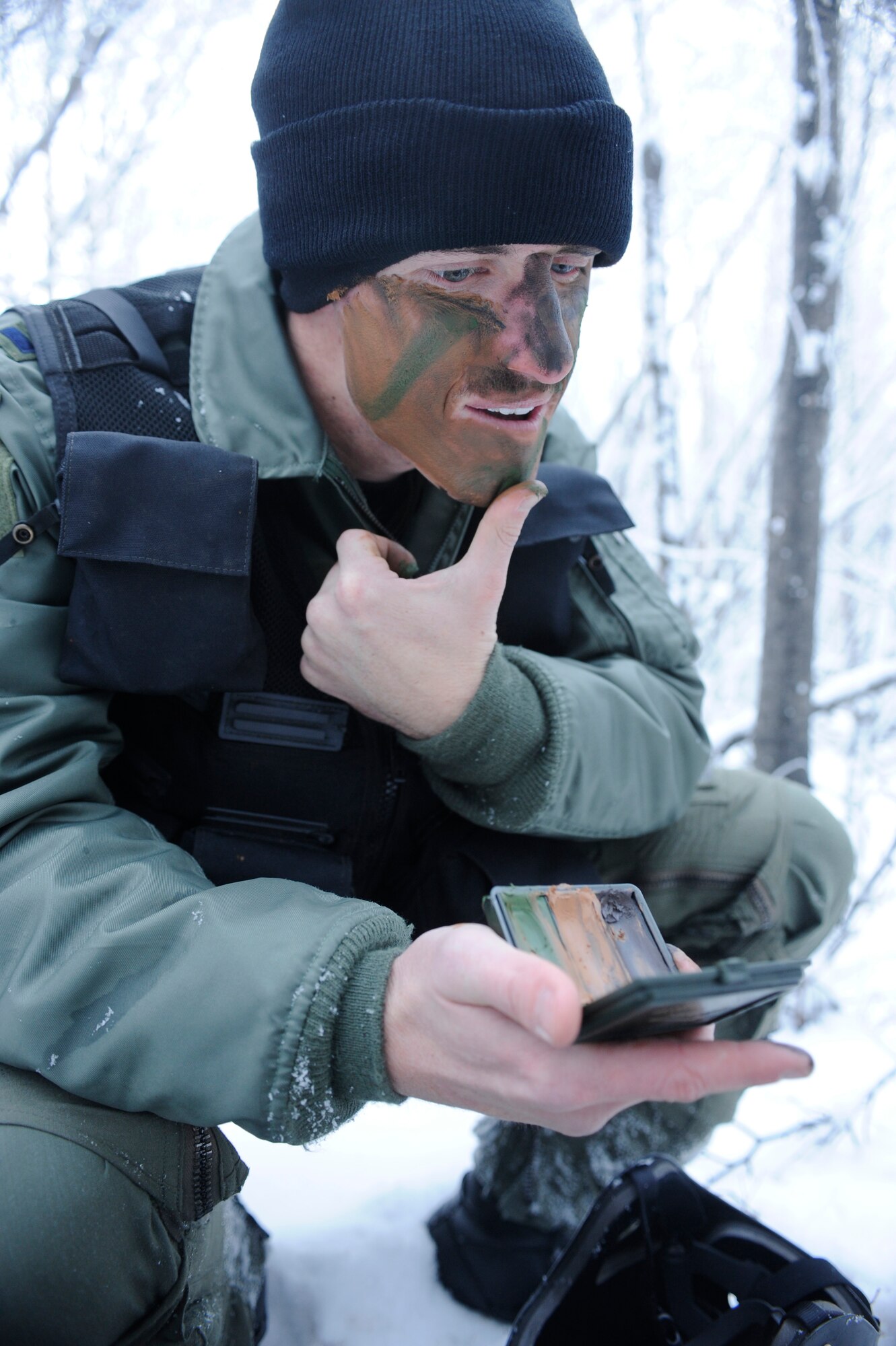 1st Lt. Matthew Feeman, 80th Fighter Squadron, Kunsan Air Base, Korea applies camo face paint to help him blend in with the enviroment during RED FLAG-Alaska 09-1 Oct. 14, 2008, at Eielson Air Force Base, Alaska. Lieutenant Feeman is playing the role of a pilot who was shot down behind enemy lines and he must now survive, evade, resist and escape to successfully complete the training mission.  (U.S. Air Force photo/Senior Airman Jonathan Snyder)