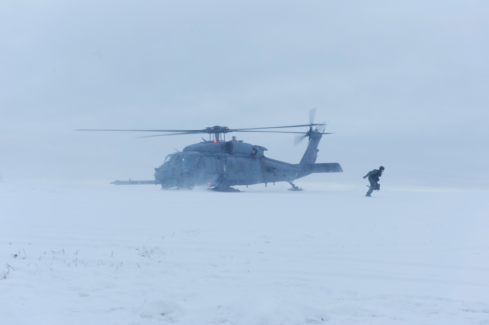 1st Lt. Matthew Feeman, 80th Fighter Squadron, Kunsan Air Base, Korea exits from a HH-60 Pave Hawk out onto the Pacific Alaskan Range Complex during RED FLAG-Alaska 09-1 Oct. 14, 2008, at Eielson Air Force Base, Alaska. RF-A is a Pacific Air Forces-directed field training exercise for U.S. and coalition forces flown under simulated air-combat conditions. It is conducted on the PARC with air operations flown out of Eielson and Elmendorf Air Force Bases. The aircraft is assigned to Detachment 1, 210th Rescue Squadron.  (U.S. Air Force photo/Senior Airman Jonathan Snyder)