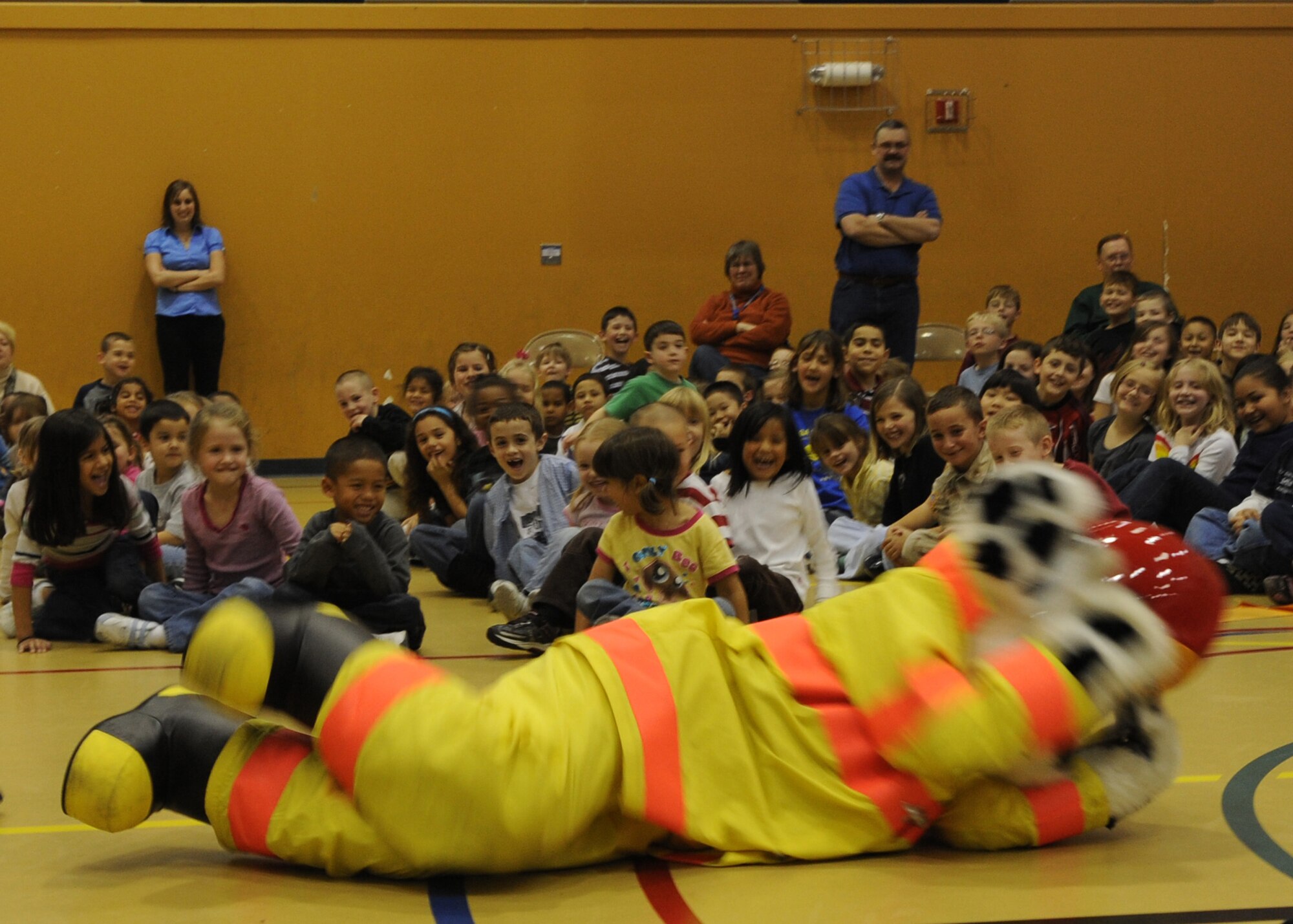 FORT RICHARDSON, Alaska -- Sparky the Fire Dog demonstrates how to "stop, drop, and roll" at Ursa Minor Elementary on Fort Richardson. This method is used to help exhaust fires on clothing. (U.S. Air Force photo/Airman 1st Class Kristin High)