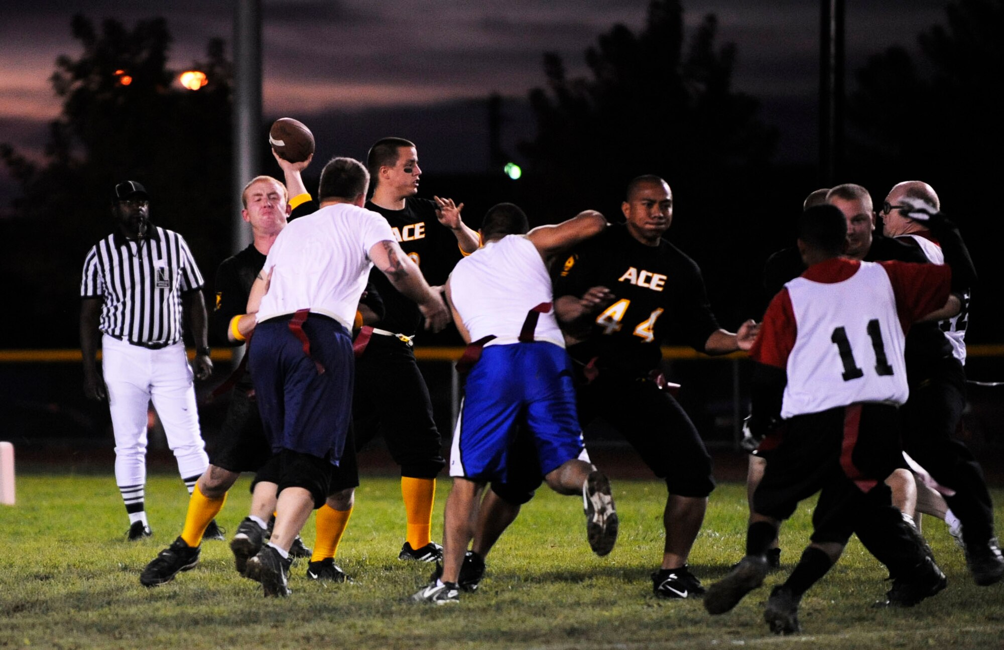 MOUNTAIN HOME AIR FORCE BASE, Idaho -- Kohl Riddell, Airmen Committed to Excellence quarterback, throws a pass while his offensive line blocks members of the 366th Force Support Squadron team Oct. 6. A.C.E. joined the flag football season with their own team while the 366th Services Squadron and 366th Mission Support Squadron have merged and created the 366th FSS. A.C.E. clobbered 366th FSS 14-8. The flag football season runs until Nov. 25. (U.S. Air Force photo/Airman 1st Class Ryan Crane)