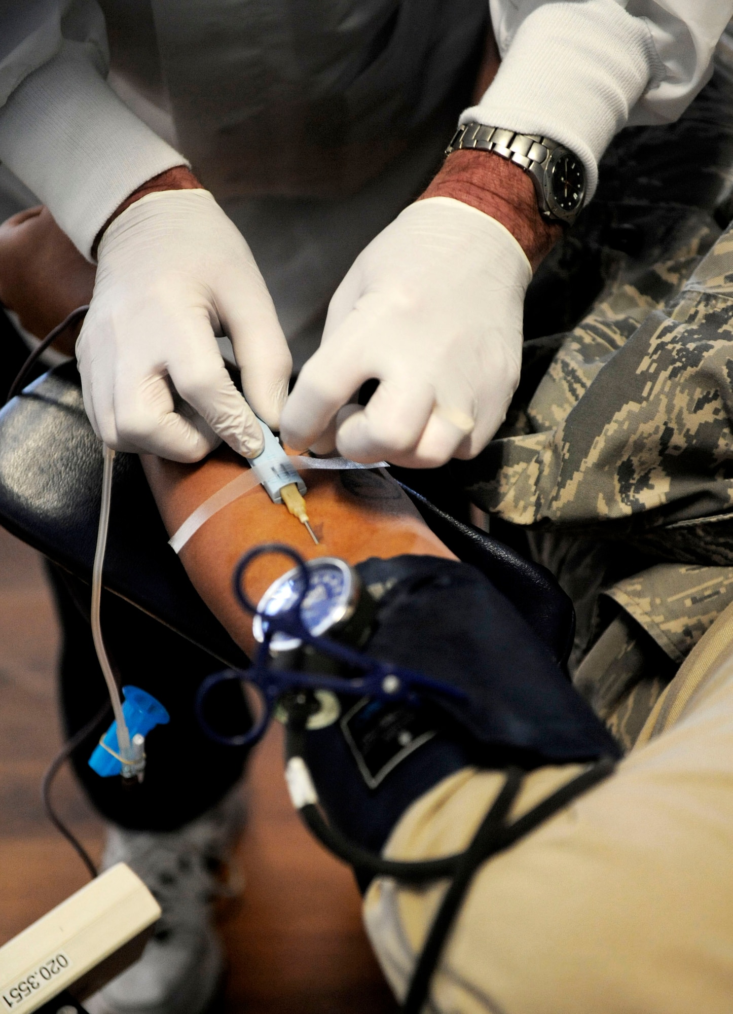 MOUNTAIN HOME AIR FORCE BASE, Idaho - Bill Williard, Red Cross technician, inserts a needle in the arm of Senior Airman Robert Lee, 366th Civil Engineer Squadron, Oct. 8. The 366th Fighter Wing hosted a blood drive for the American Red Cross, collecting 109 units of blood, tying our record for the most units ever collected at Mountain Home AFB. Coincidently, Gunfighters donated exactly 109 units of blood during the drive held only weeks following the events of Sept. 11, 2001. (U.S. Air Force photo/ Airman 1st Class Ryan Crane)