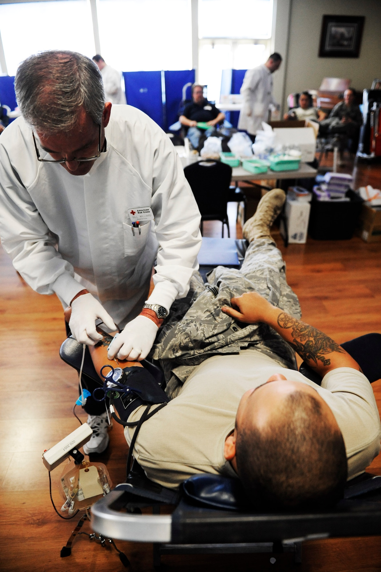 MOUNTAIN HOME AIR FORCE BASE, Idaho - Senior Airman Robert Lee, 366th Civil Engineer Squadron, lays back in his chair as, Bill Williard, Red Cross technician, inserts the needle into Airman Lee's arm Oct. 8. The 366th Fighter Wing hosted a blood drive for the American Red Cross, collecting 109 units of blood, tying our record for the most units ever collected at Mountain Home AFB. Coincidently, Gunfighters donated exactly 109 units of blood during the drive held only weeks following the events of Sept. 11, 2001. (U.S. Air Force photo/ Airman 1st Class Ryan Crane)