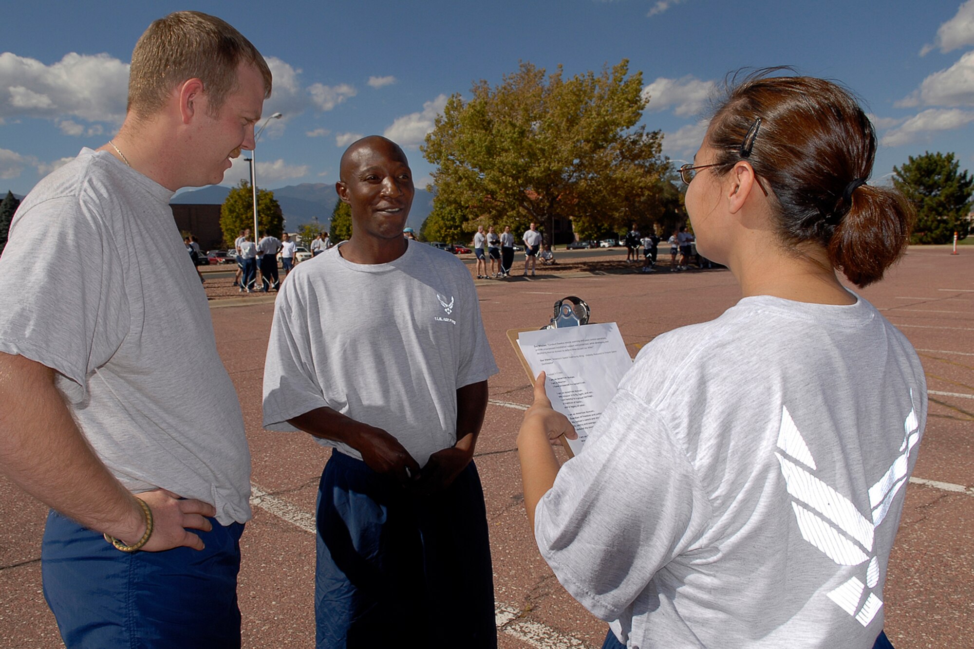 Tech. Sgt. Felicia Beyale, 21st Security Forces Squadron, tests Tech. Sgt. Scott Anderson and Tech. Sgt. Bernard Bedminster of the 21st Operations Support Squadron on their combined knowledge of the 21st SW Mission and Vision statements as well as the recital of the Airman’s Creed during the last phase of Wingman’s Day at Peterson AFB on Oct. 10.  The Air Force established the Wingman program to encourage Airmen and their families to look out for each other and to intervene when signs of stress are observed. It's a promise, a pledge, a commitment between Airmen. (Air Force photo/Rob Bussard)