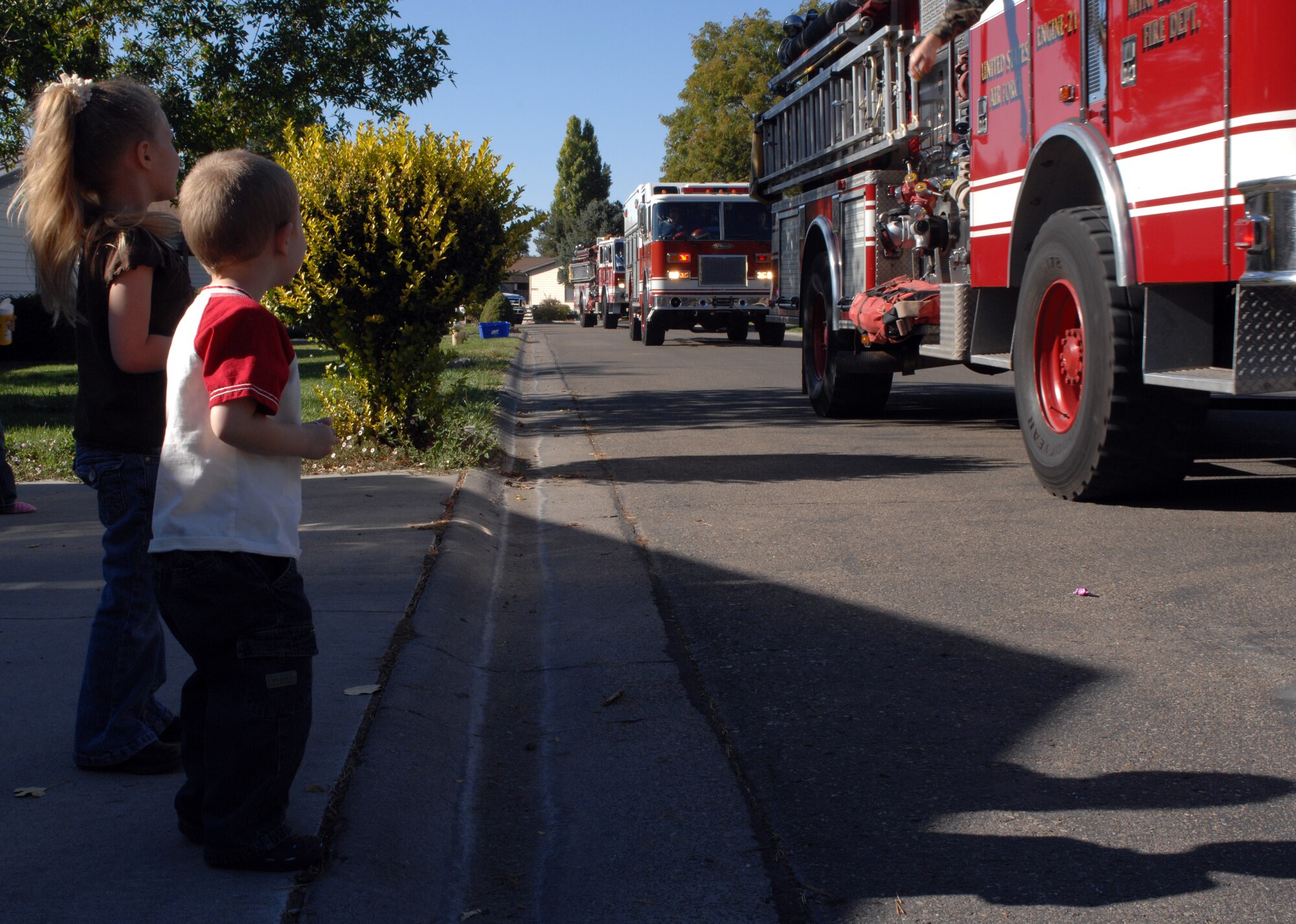 MOUNTAIN HOME AIR FORCE BASE, Idaho - Jaylee Carter, 5, and Shawn Carter, 3, watch the Fire Prevention Week parade going through base housing Oct. 6. The base fire department joined forces with the National Fire Protection Association to remind Gunfighters of fire prevention techniques. (U.S. Air Force photo/ Airman 1st Class Ashley Tank) 