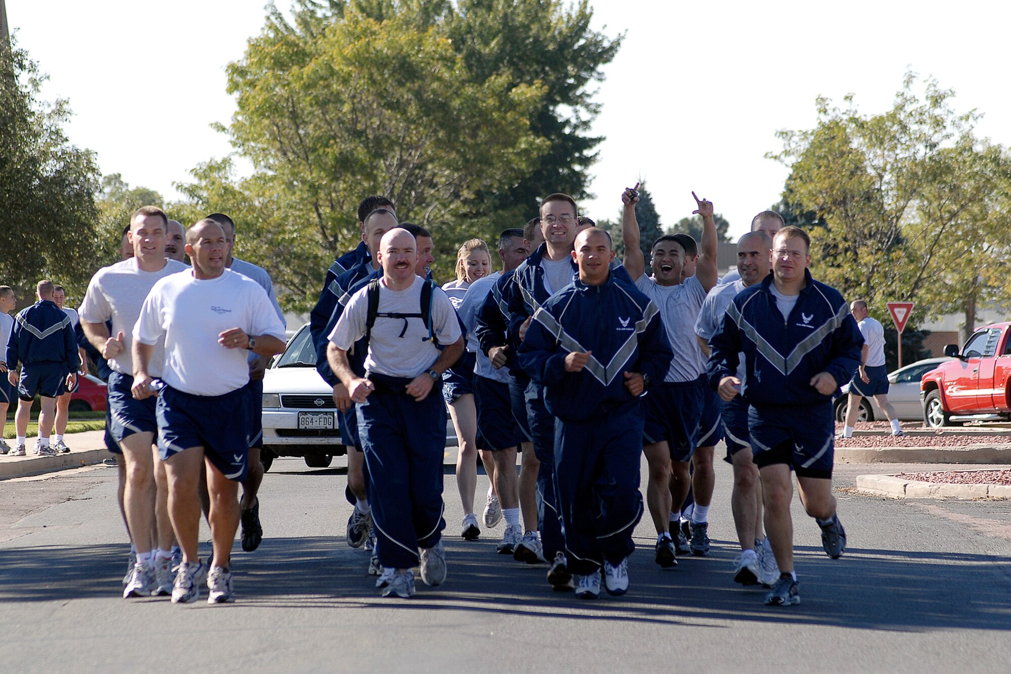 The second team to run on Wingman Day sets out from the Base Theater to their first stop; the softball fields, where they will participate in the Pile Move.  The Air Force established the Wingman program to encourage Airmen and their families to look out for each other and to intervene when signs of stress are observed. It's a promise, a pledge, a commitment between Airmen. (Air Force photo/Rob Bussard)