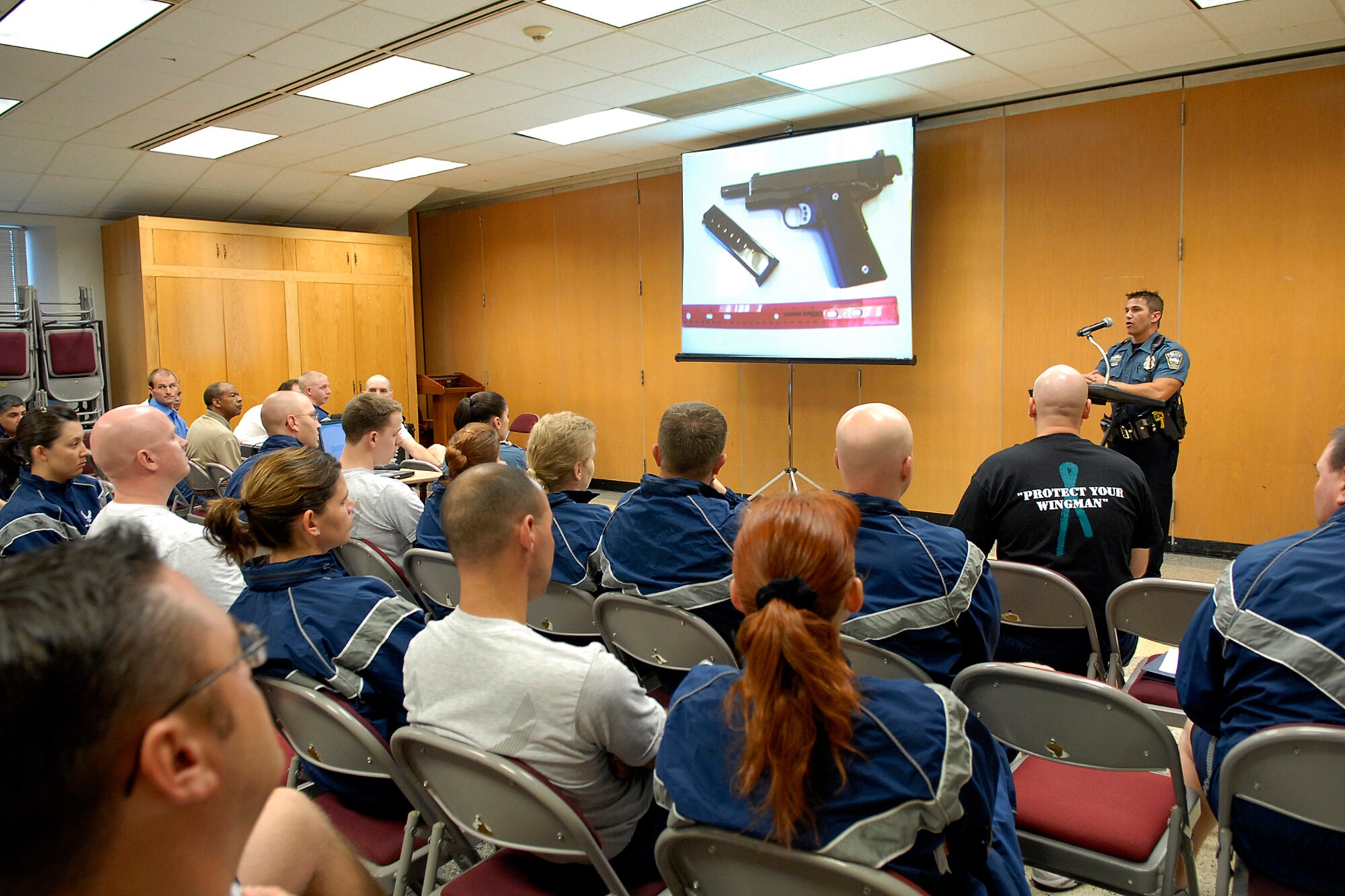 Officer Jackson Andrews of the Colorado Springs Police Department briefs Peterson Airmen about local gang activity, methods of operation, spray-paint tagging definitions and how to protect oneself.  Officers Andrews and Kundert provided the briefing at the Base Chapel during the 21st Space Wings’ Wingman Day Oct 10. (Air Force photo/Rob Bussard)