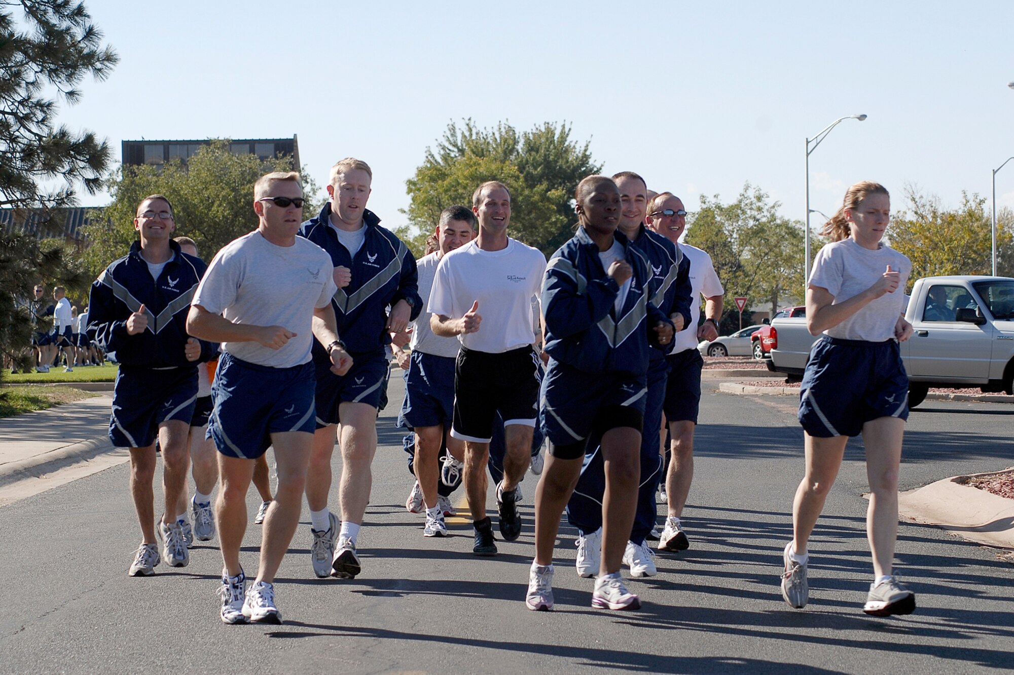 The third team to run on Wingman Day Oct. 10, 2008, sets out from the Base Theater to their first stop; the softball fields, where they will participate in the Pile Move Challenge.  The Air Force established the Wingman program to encourage Airmen and their families to look out for each other and to intervene when signs of stress are observed. It's a promise, a pledge, a commitment between Airmen. (Air Force photo/Rob Bussard)
