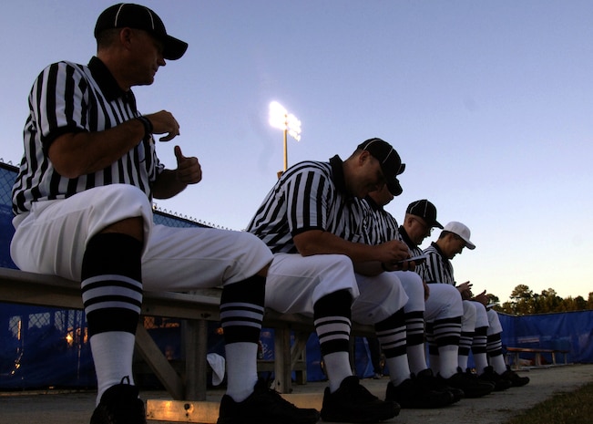 Randall Edwards, Ed Ebersole, Scott Vendrely, Sean Houlihan and Rocky Huggins talk during halftime of the Colleton County High School and Fort Dorchester High School freshman game in North Charleston, S.C., Oct. 2. The officials are all Airmen or former Airmen who volunteer their time to the community as football officials. (U.S. Air Force photo/Airman 1st Class Timothy Taylor)