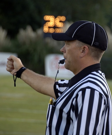 Randall Edwards signals that there are 11 players on defense during the Colleton County High School and Fort Dorchester High School freshman game in North Charleston, S.C., Oct. 2. The officiating crew is made up of Airmen or former Airmen who give back to the community through officiating high school, middle school and recreation department football games. Edwards is a master sergeant with the 437th Aerial Port Squadron here at Charleston AFB.  (U.S. Air Force photo/Airman 1st Class Timothy Taylor)
