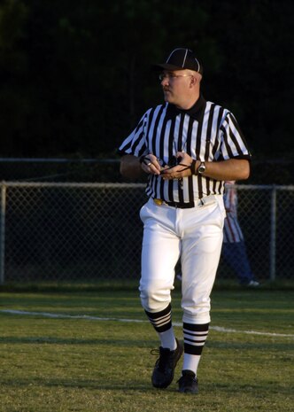 Sean Houlihan observes Colleton County High School and Fort Dorchester High School players during the freshman game in North Charleston, S.C., Oct. 2. The officiating crew is made up of Airmen or former Airmen who give back to the community through officiating high school, middle school and recreation department football games. Houlihan is a master sergeant assigned to the 437th Airlift Wing at Charleston AFB. (U.S. Air Force photo/Airman 1st Class Timothy Taylor)