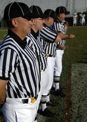 From left to right, Randall Edwards, Sean Houlihan, Ed Ebersole and Scott Vendrely watch the pregame conference before the beginning of the Colleton County High School and Fort Dorchester High School freshman game in North Charleston, S.C., Oct. 2. Ebersole is a retired master sergeant and the other three officials are senior NCOs assigned to Charleston AFB. The officiating crew is made up of Airmen or former Airmen who give back to the community through officiating high school, middle school and recreation department football games. (U.S. Air Force photo/Airman 1st Class Timothy Taylor)