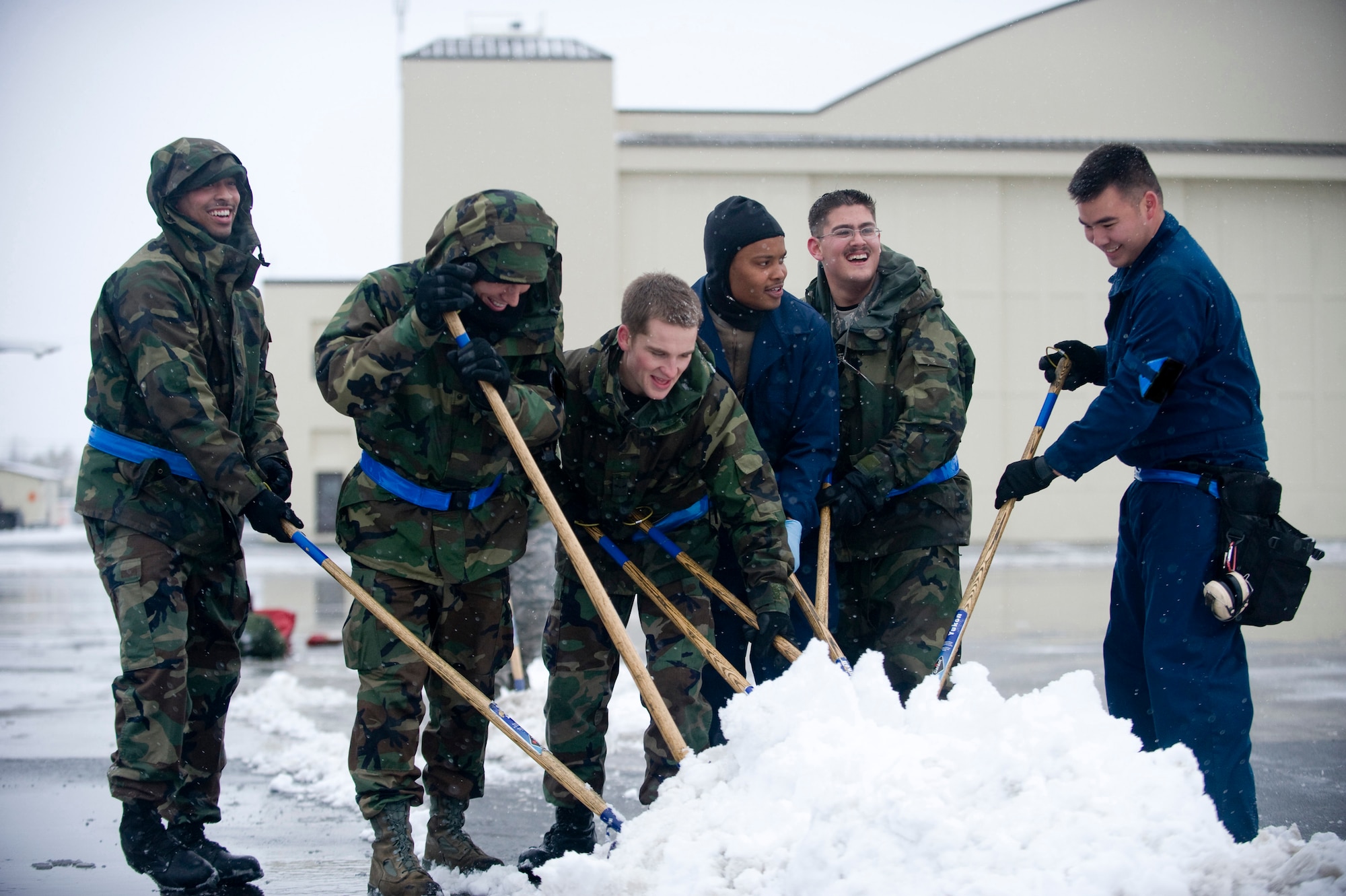 ELMENDORF AIR FORCE BASE, Alaska -- Maintainers of the 19th Aircraft Maintenance Unit pile snow from the flightline Oct. 14. The 19th AMU maintains the F-15s in Alaska's extreme winter conditions. (U.S. Air Force photo/Senior Airman Jonathan Steffen)