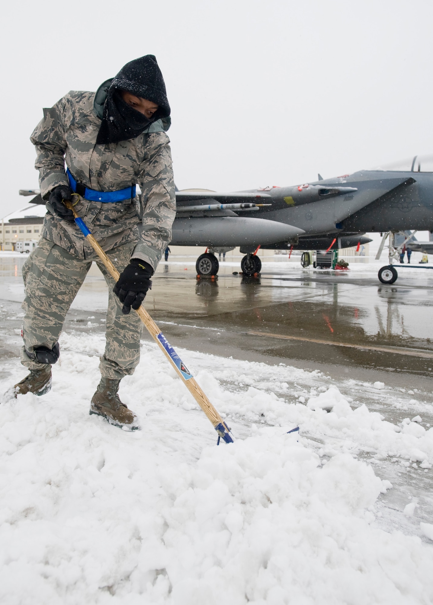ELMENDORF AIR FORCE BASE, Alaska -- Airman Armon Taylor, 19th Aircraft Maintenance Unit, plows snow away from the F-15C Eagle Oct. 14. The 19th AMU maintains the F-15s in Alaska's extreme winter conditions. (U.S. Air Force photo/Senior Airman Jonathan Steffen)