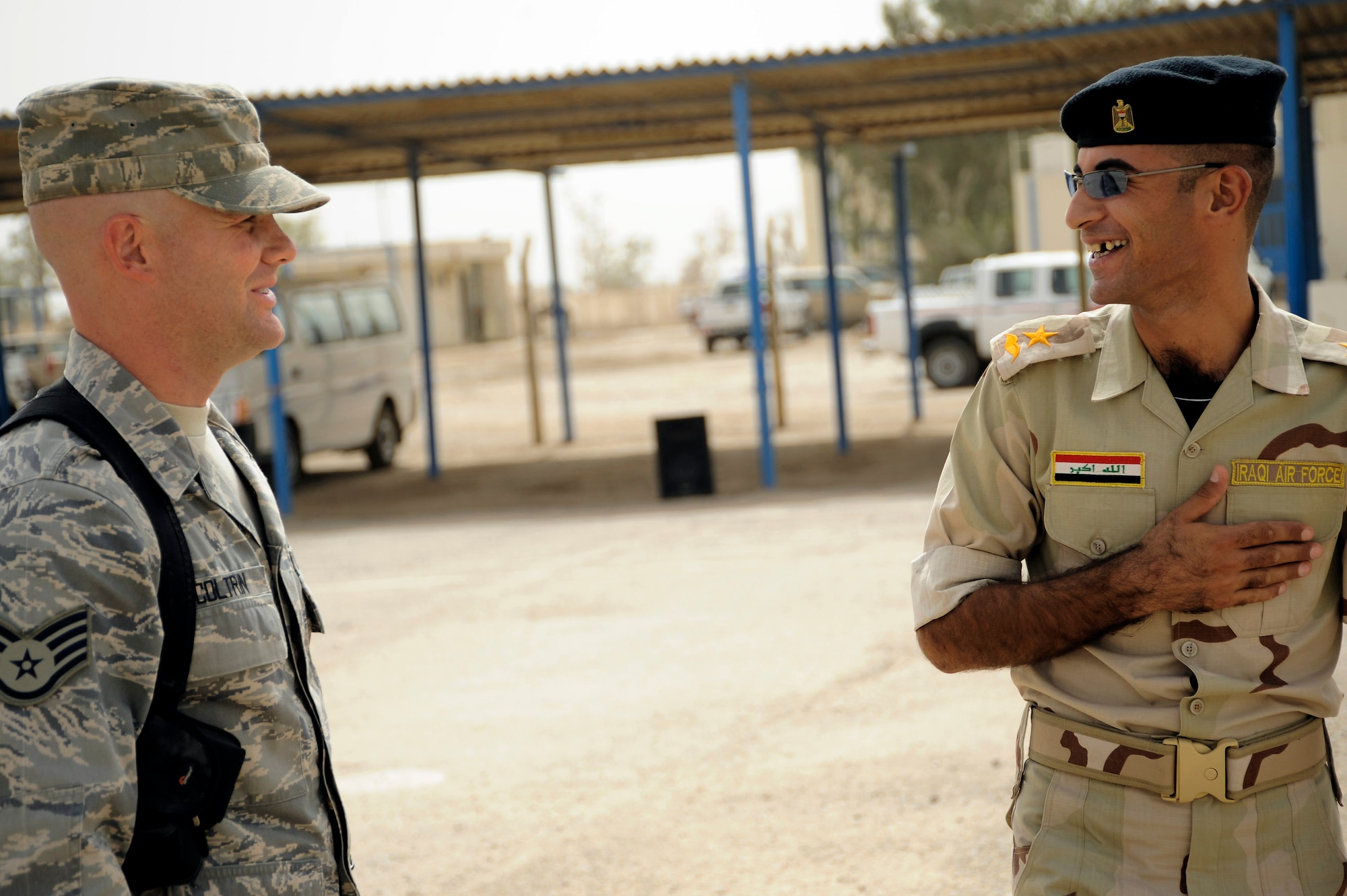 Staff Sgt. Matthew Coltrin (left) talks about the training day with Iraqi air force Lt. Layth Sept. 28 at Al Taji Air Base, Iraq. Sergeant Coltrin advises the Iraqi military training instructors on how to conduct physical training, dorm set up, drill and lectures. Sergeant Coltrin is a military training instructor air adviser with the 370th Expeditionary Training Squadron. Lieutenant Laythe is an Iraqi military training instructor. (U.S. Air Force photo/Staff Sgt. Paul Villanueva II) 
