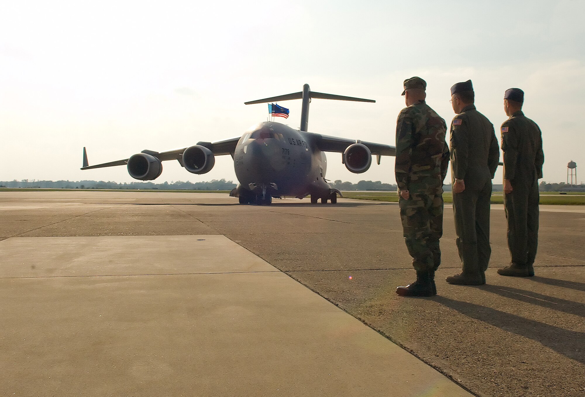 Chief Master Sgt. John Wood (far left), 436th Airlift Wing command chief, Col. Randal Bright, 512th AW commander, and Col. Steven Harrison, 436th AW commander, welcome Dover's newest C-17 Globemaster III, The Spirit of Delaware, during a ceremony at the Air Mobility Command Museum Oct. 8, 2008.  (U.S. Air Force photo/Roland Balik)