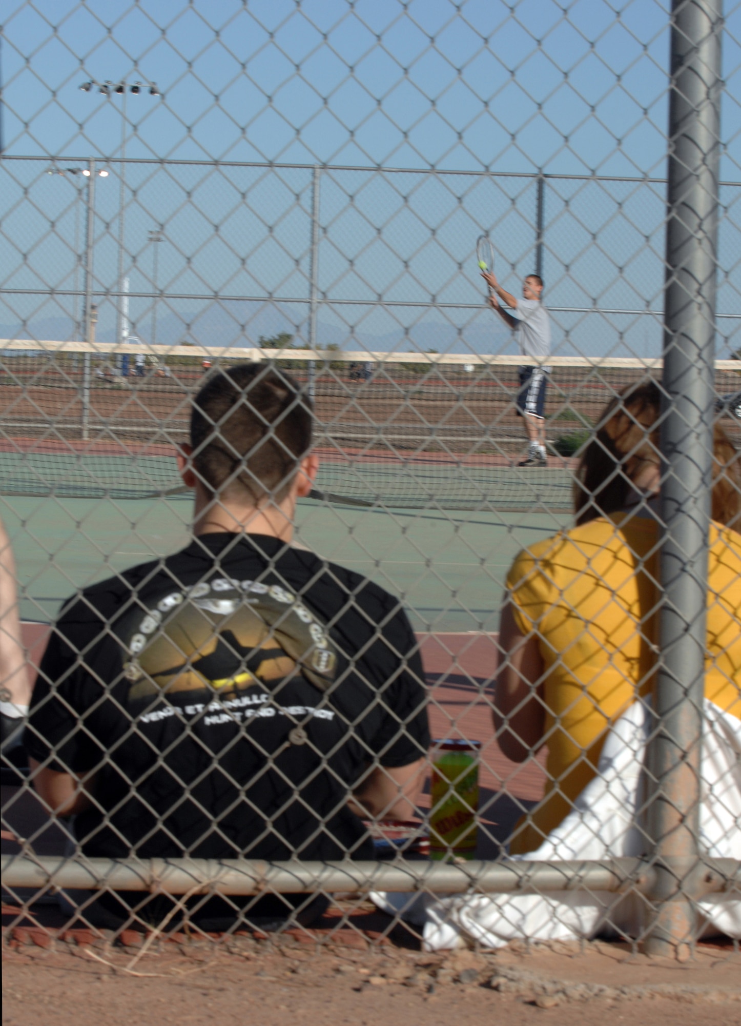 Spectators watch the game of tennis between Airman 1st Class Miles Mendez, 49th Materiel Maintenance Group, and Capt. Chris Rosales, 49th Logistics Readiness Squadron, during Sports Day at the Fitness and Sports Center at Holloman Air Force Base, N.M., October 10. More than 20 tennis players participated in the competition. (U.S. Air Force photo/Airman Sondra M. Escutia)