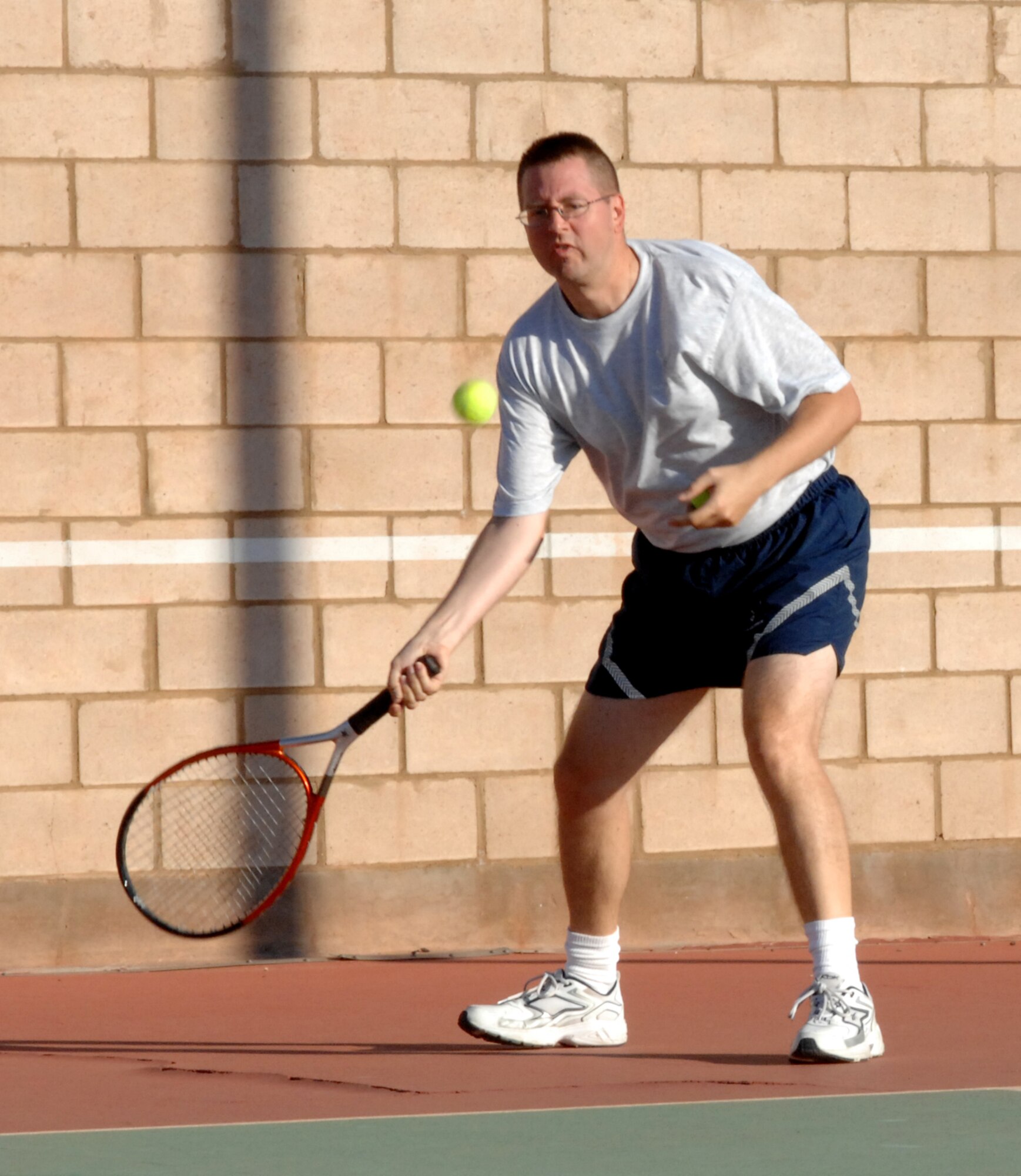 Tech. Sgt. Buckman, 49th Materiel Maintenance Support Squadron, aims to hit the tennis ball during his first match in the tennis competition on Sports Day at Holloman Air Force Base, N.M., October 10. Sergeant Buckman won the overall competition for large squadrons. (U.S. Air Force photo/Airman Sondra M. Escutia)