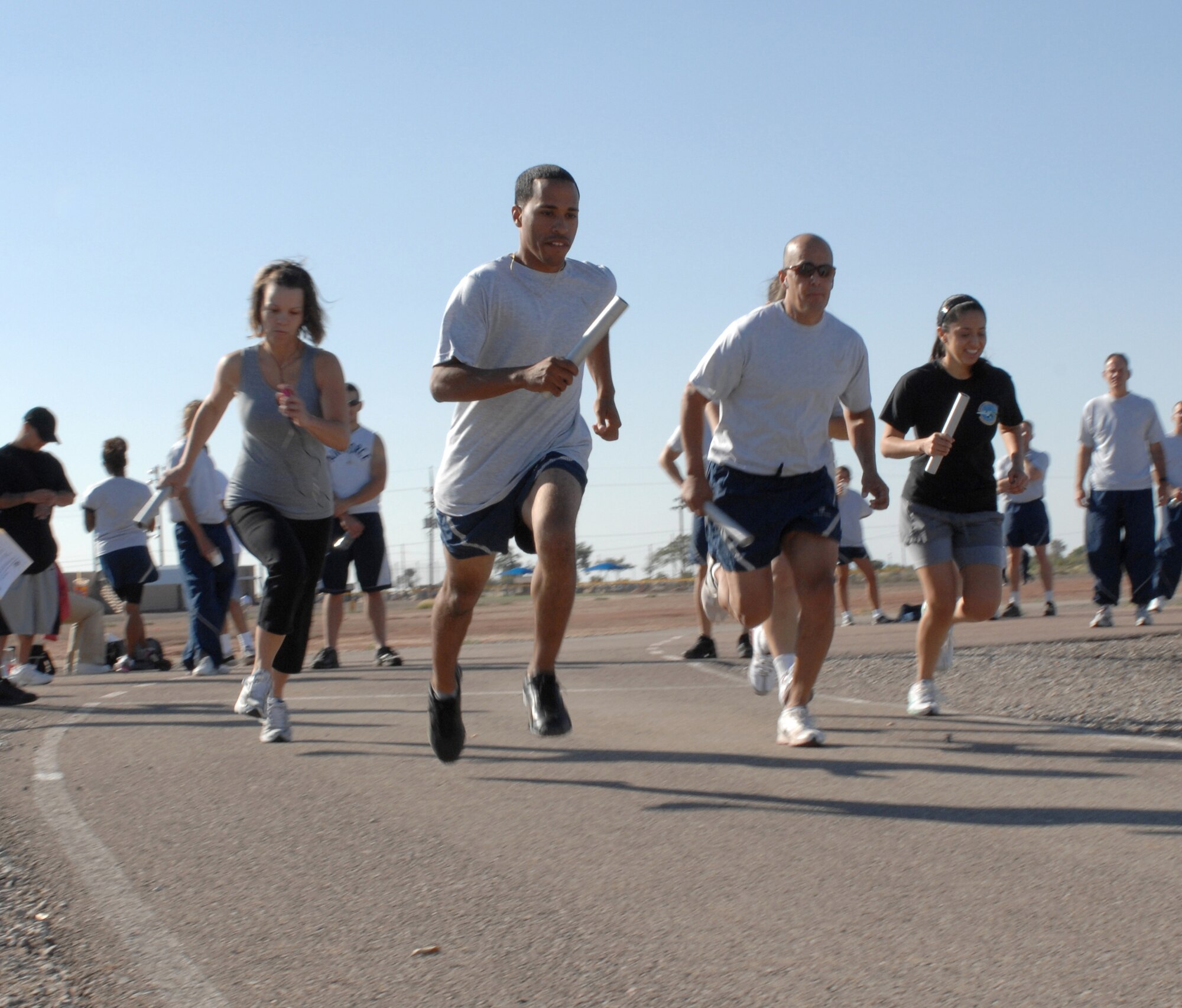 Five members of the small squadron category begin to run their portion of the three-mile relay during Sports Day at Holloman Air Force Base, N.M., October 10. Each member of the three-person team ran one mile with a baton before handing it off to the next person. (U.S. Air Force photo/Airman Sondra M. Escutia)