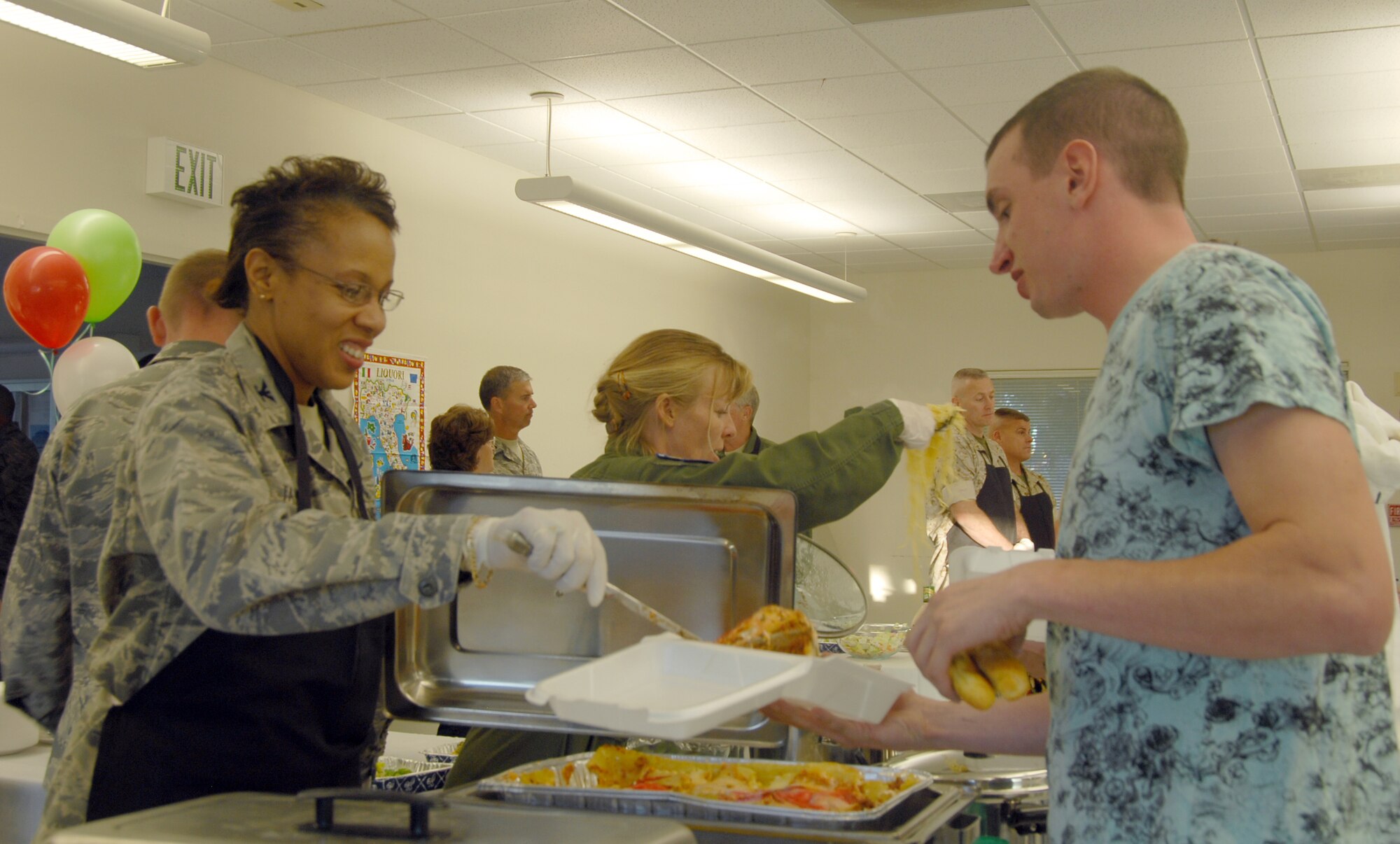 Col. Janet Taylor, 95th Medical Group commander, serves food to a dormitory residents during a free dorm-dweller dinner at the Chapel 1 annex Oct. 14. The dorm-dweller dinner is a monthly event sponsored by Edwards private organizations. (Air Force photo by 2nd Lt. Belena Stuart)