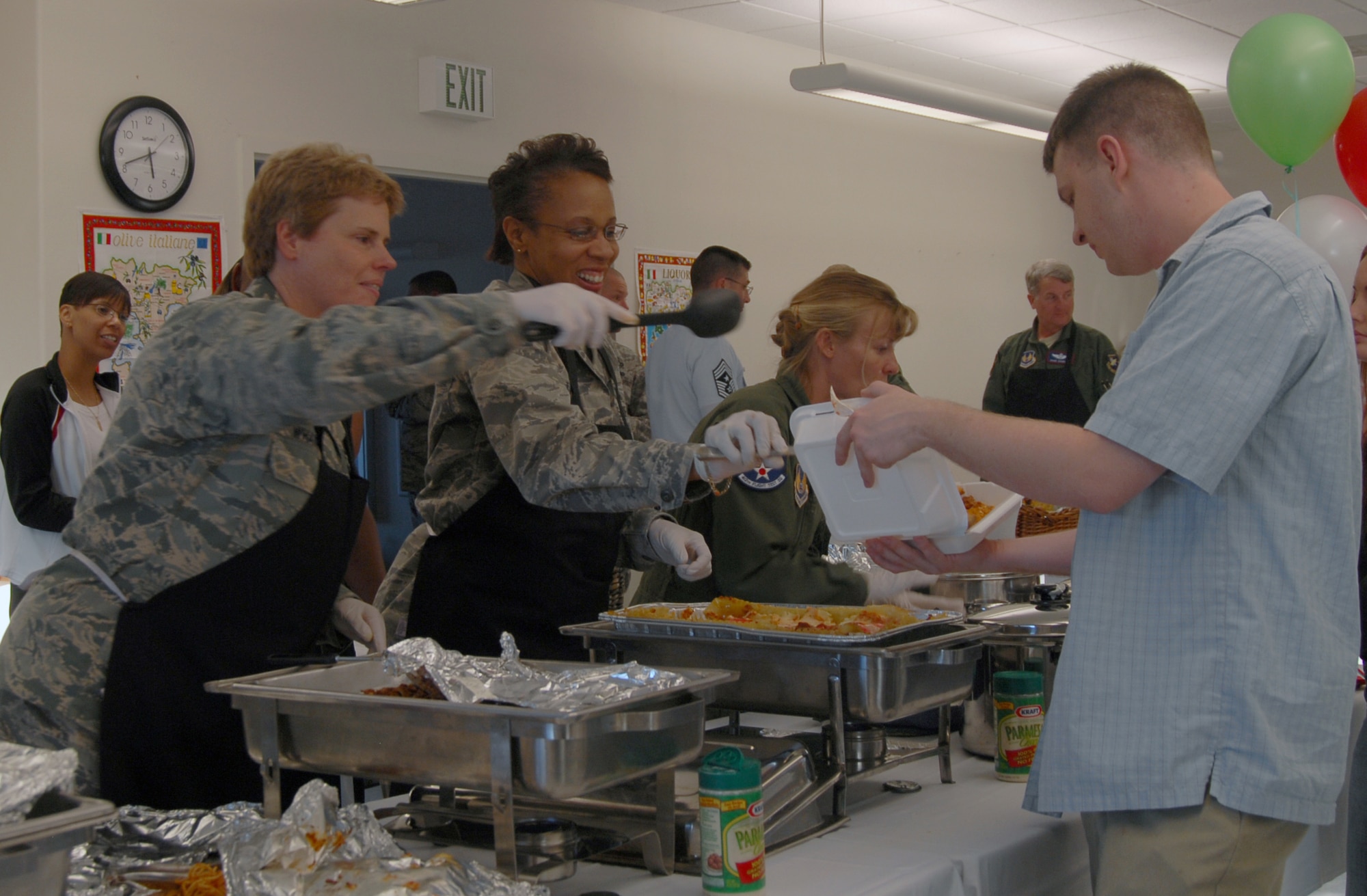 Col. Nancy Wharton (left), 95th Air Base Wing vice commander (middle), and Col. Janet Taylor, 95th Medical Group commander, serve food to a dormitory resident during a free dorm-dweller dinner at the Chapel 1 annex Oct. 14. The Edwards Top 3 sponsored the event. (Air Force photo by 2nd Lt. Belena Stuart)