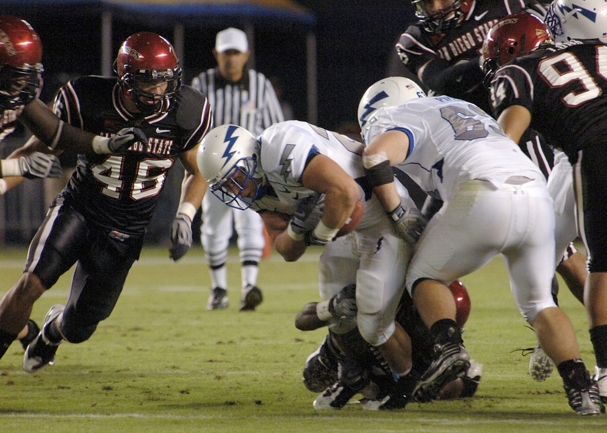 U.S. Air Force Academy Falcons fullback Todd Newell drags a tackler as he rushes for additional yardage Oct. 11 in a game against San Diego State in San Diego. Newell, a San Diego native and team captain, carried the ball 19 times for 77 yards and a touchdown in the Falcons' 35-10 win over San Diego State. (U.S. Air Force photo/Staff Sgt. Steve Grever) 
