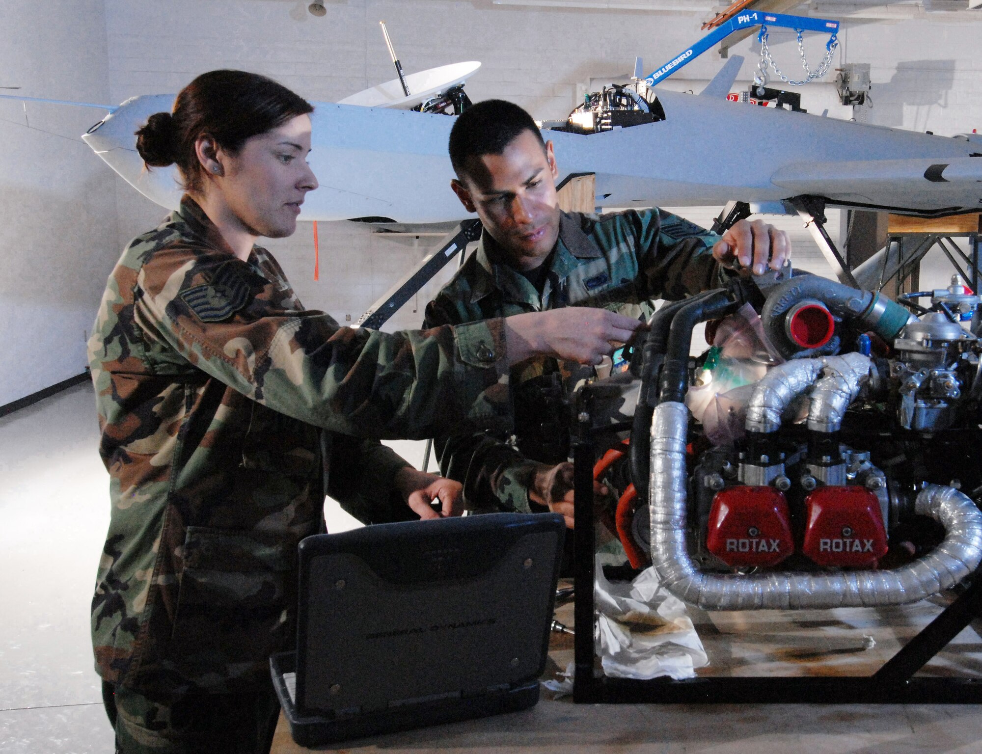 Tech. Sgt. Rebecca Hatfield (left), an instructor with Field Training Detachment 26 of the California Air National Guard's 163rd Maintenance Group, reviews procedures Oct. 15 with Staff Sgt. Carlos Barrera to install an oil pump on the engine of an MQ-1 Predator unmanned aircraft.  Sergeant Barrera is a crew chief assigned to the 163rd Reconnaissance Wing at March Air Reserve Base, Calif. Airmen with Det. 26 train active duty, Reserve and Air National Guard personnel on Predator maintenance operations. (U.S. Air Force photo/Senior Airman Matt Smith)