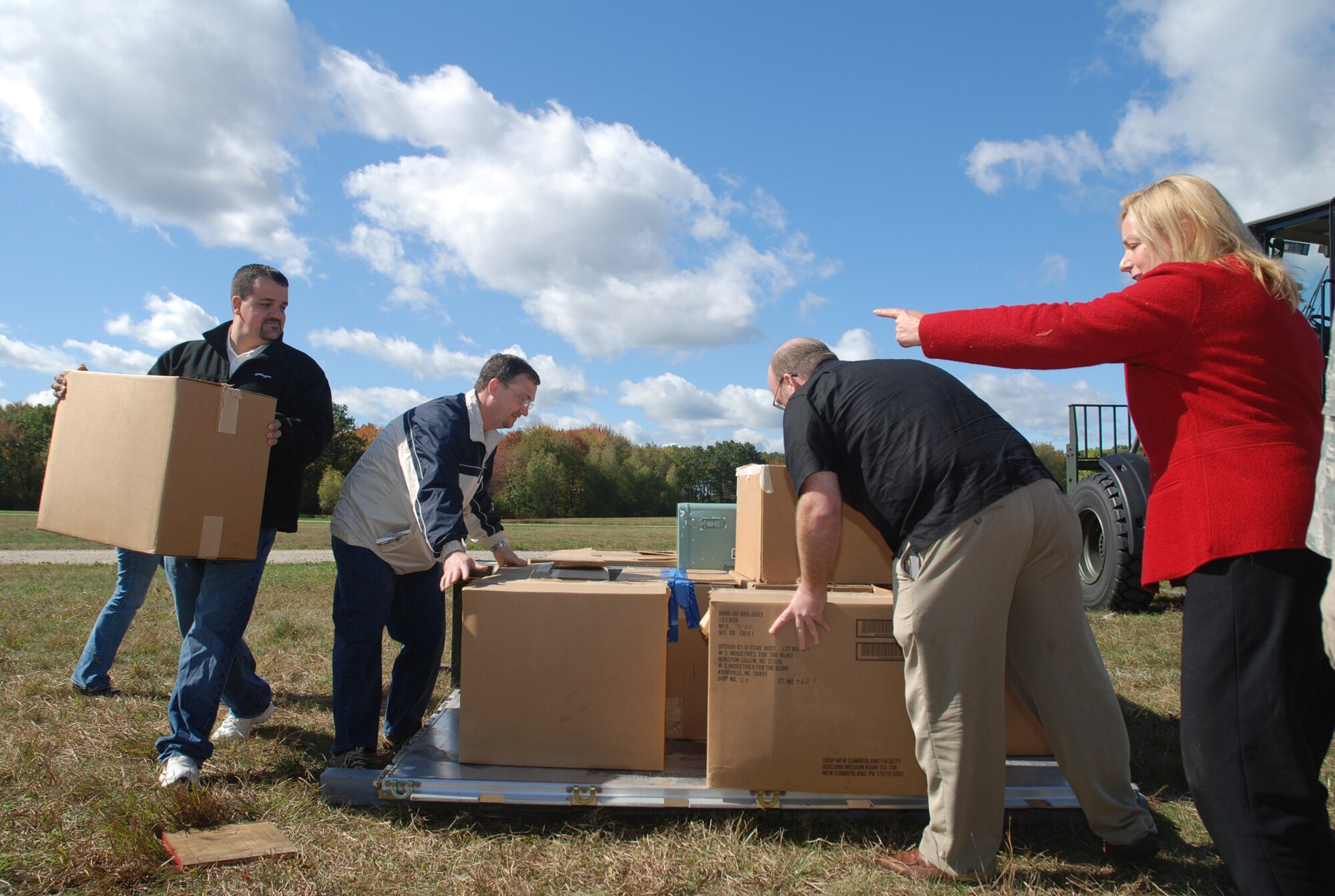 PALLET PRACTICE -- Maryanne Cataldo directs the loading of a pallet during Operation Bosslift Oct. 4. More than 20 employers who visited Westover took part in hands-on training to give them a better idea of what Air Force reservists do while at Westover. The busy schedule also included the bosses eating Meals-Ready-to-Eat for lunch, going through a simulated moblity line, and a C-5 flight over New England. (US Air Forcephoto by Tech. Sgt. Troy Thibeault)