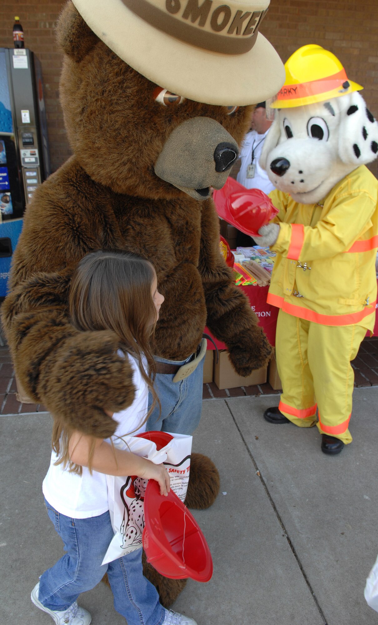 WHITEMAN AIR FORCE BASE, Mo. –Smokey the Bear and Sparky the Fire Dog give away fire prevention and safety products Oct. 11. Whiteman Fire Prevention Week was from Oct. 5-11, and the Whiteman Fire and Emergency Services Flight held several events to further educate the base populace on fire prevention and safety. (U.S. Air Force Photo/Senior Airman Stephen Linch) 