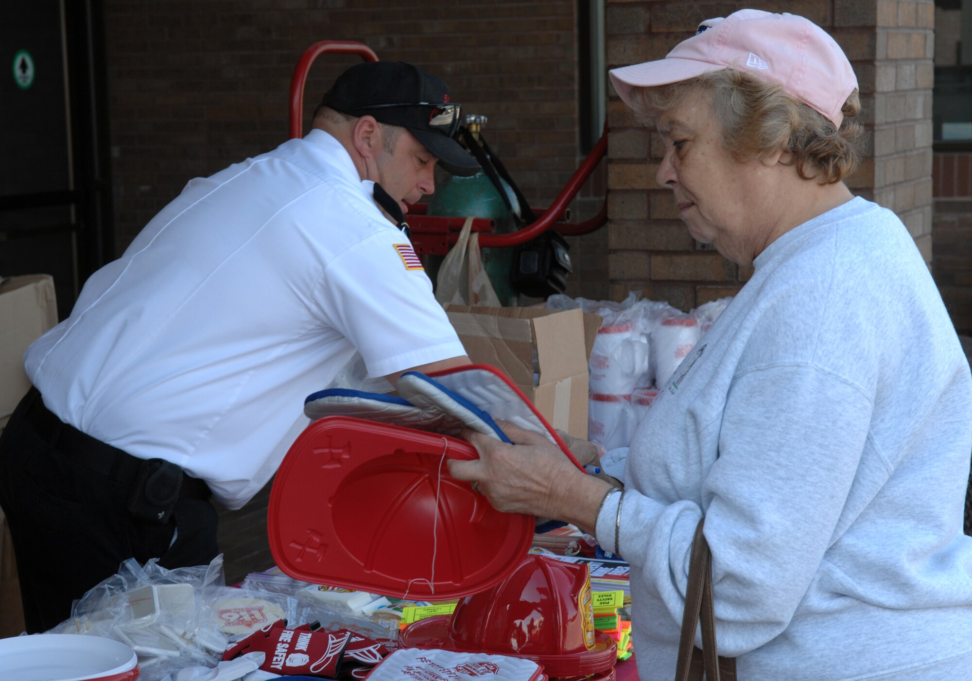 WHITEMAN AIR FORCE BASE, Mo. - Tim Robinson, Whiteman Fire Department, looks for fire prevention products to give to a woman during Fire Prevention Week. Whiteman Fire Prevention Week was from Oct. 5-11, and the Whiteman Fire and Emergency Services Flight held several events to further educate the base populace on fire prevention and safety. (U.S. Air Force Photo/Senior Airman Stephen Linch)