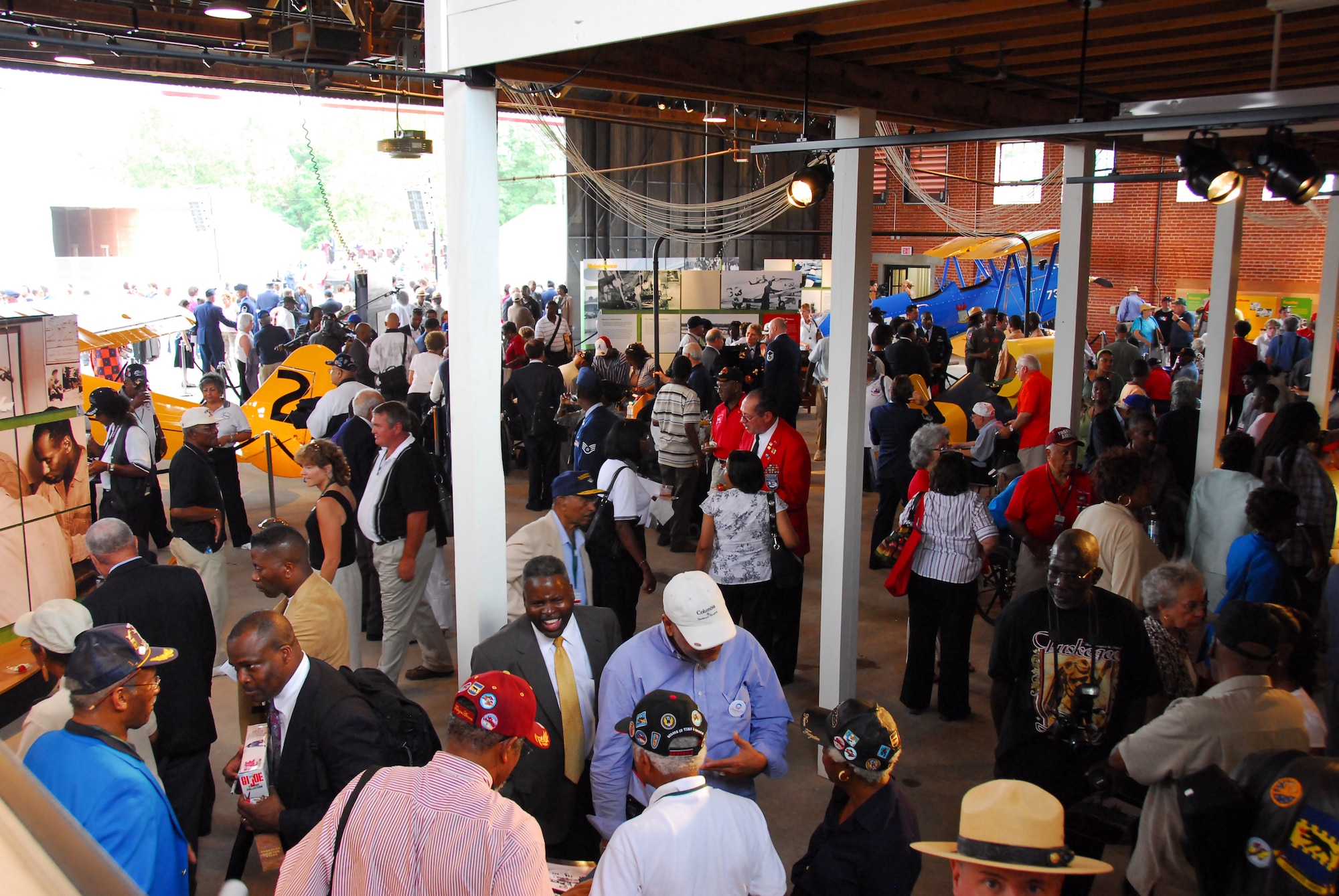 After the opening ceremony of the Tuskegee Airmen National Historic Site Oct. 10 at Moton Field, Ala., visitors explore the interpretive and static displays housed the in the only remaining original hangar of the "Tuskegee Experience." (Air Force photo by Scott Knuteson)