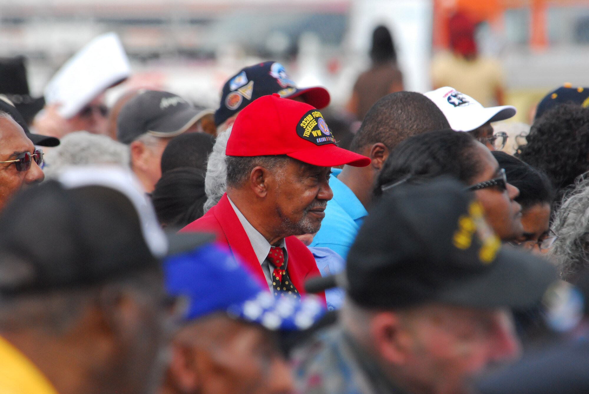 One of the Documented Original Tuskegee Airmen, or DOTAs, wears the distinctive red hat and jacket at the opening ceremony of the Tuskegee Airmen National Historic Site Oct. 10 at Moton Field, Ala. One estimate notes the Airmen, now in their late 70s and early 80s, are dying at a rate of five per week. (Air Force photo by Scott Knuteson)