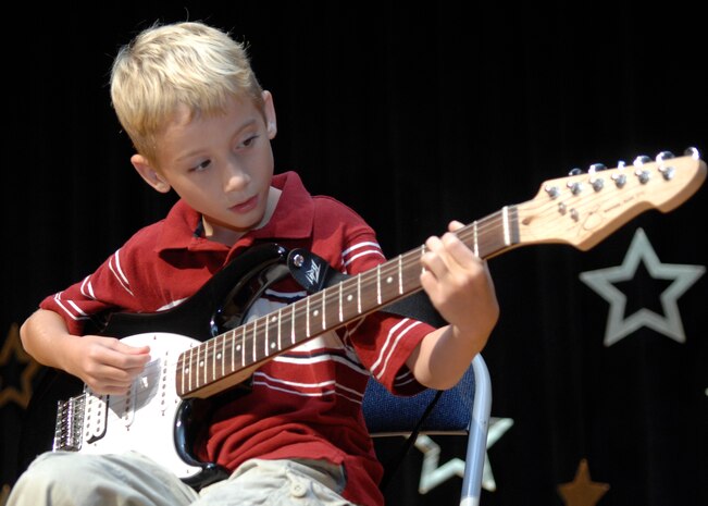 Christopher Montrose plays ?Dead or Alive? and ?Stairway to Heaven? on the guitar during the Charleston AFB Family and Teen Talent Contest at the base theater Oct. 9. Christopher won the 6-8-year-old solo act category. Christopher is the son of Tech. Sgt. Mark Montrose from the 437th Force Support Squadron. (U.S. Air Force photo/Airman 1st Class Katie Gieratz)
