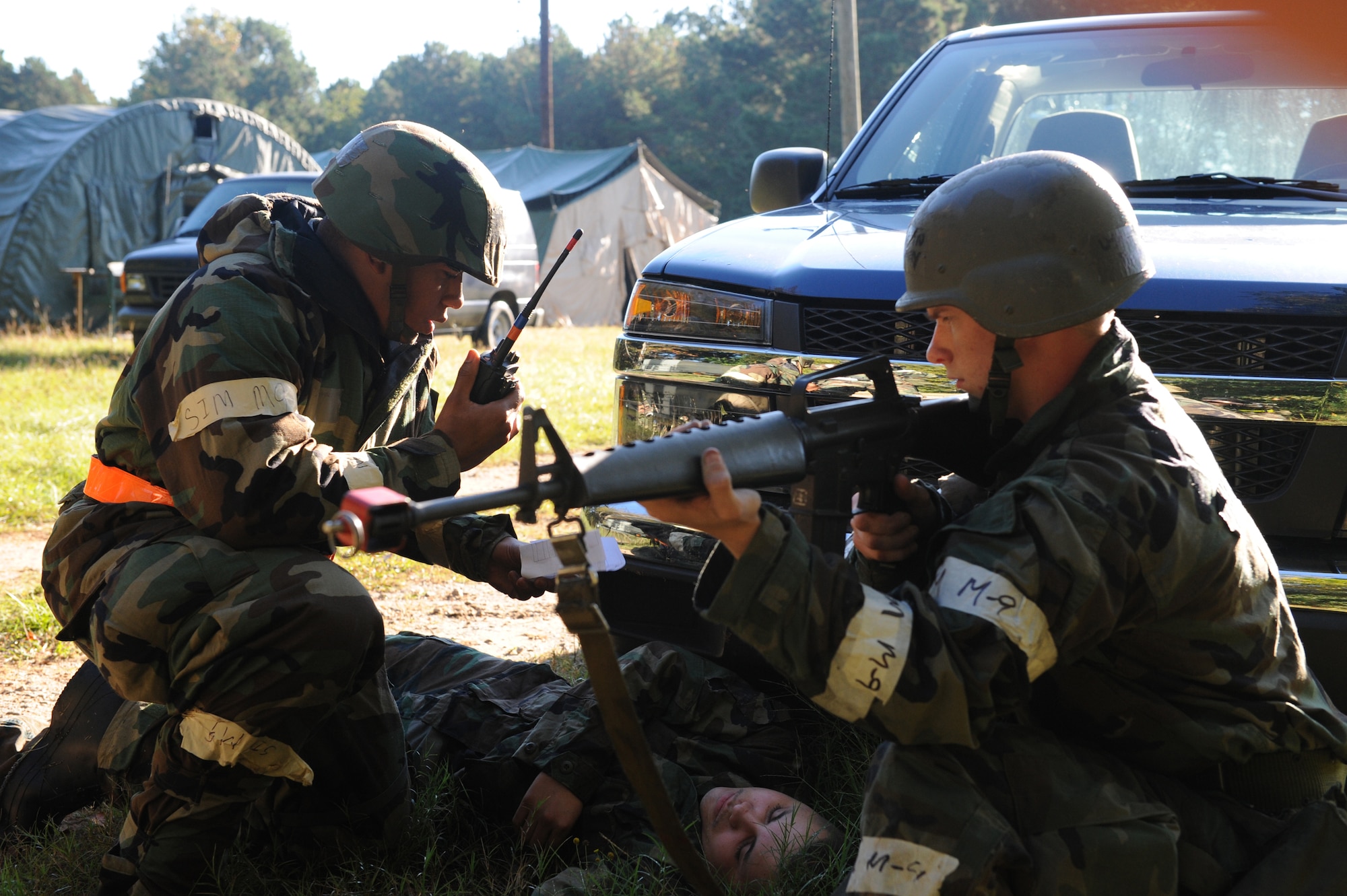 SHAW AIR FORCE BASE, S.C. -- Staff Sgt. Andre Edwards, 20th Civil Engineer Squadron, radios in the injuries of a wounded insurgent while Airman Donald Jabaay, 20th CES, keeps watch during a Phase II Operational Readiness Exercise Oct 15. OREs test and evaluate deployment readiness. (U.S. Air Force photo/Staff Sgt. Henry Hoegen)