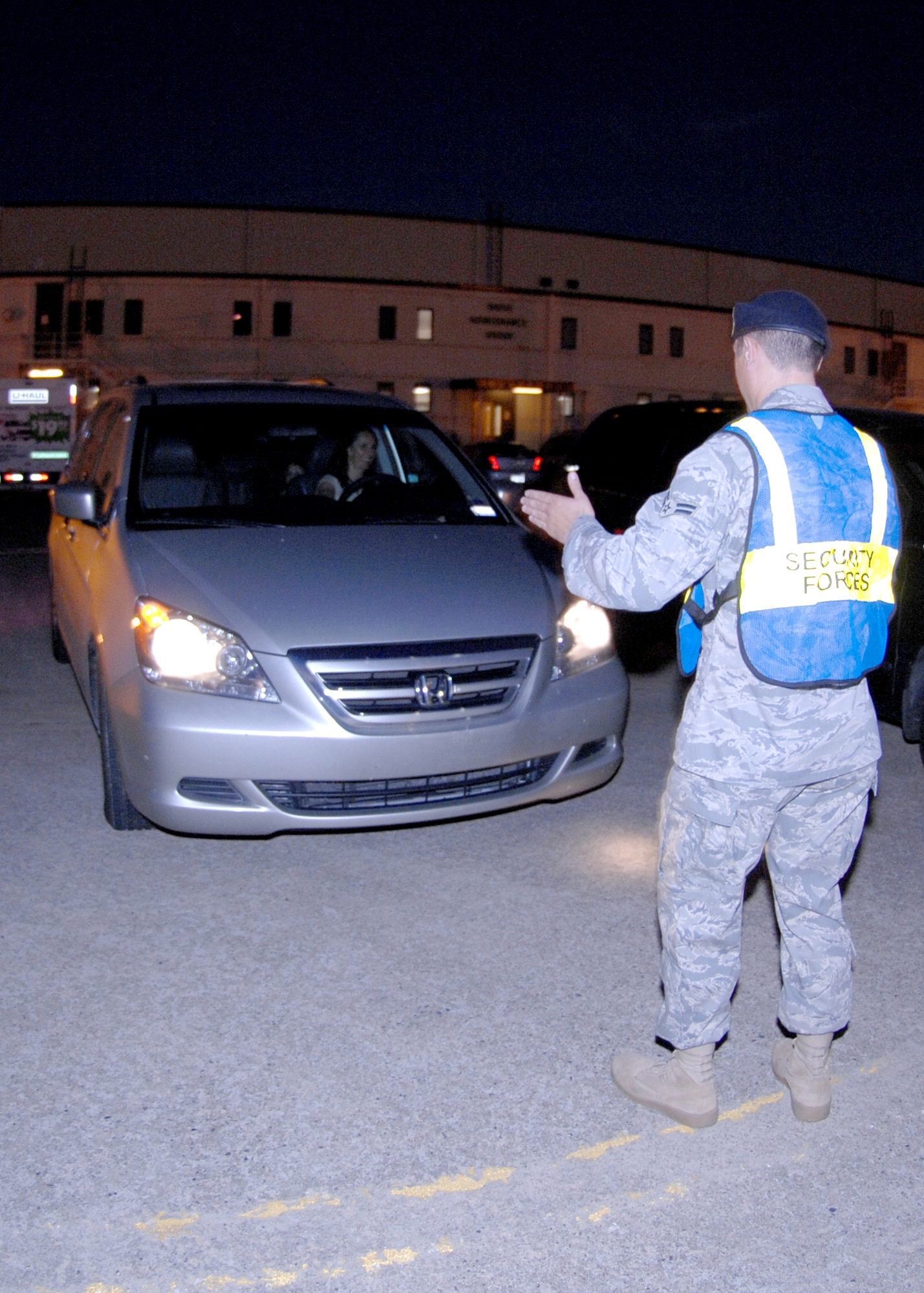 Members of the 4th Security Forces Squadron direct traffic for the Tops in Blue performance in the 916th Air Refueling Wing Hanger here on Seymour Johnson Air Force Base, N.C., Oct. 14, 2008.The 4th SFS had about 20 Airmen directing traffic before and after the performance to ensure safety. (U.S. Air Force Photo by Airman 1st Class Rae A. Perry)
