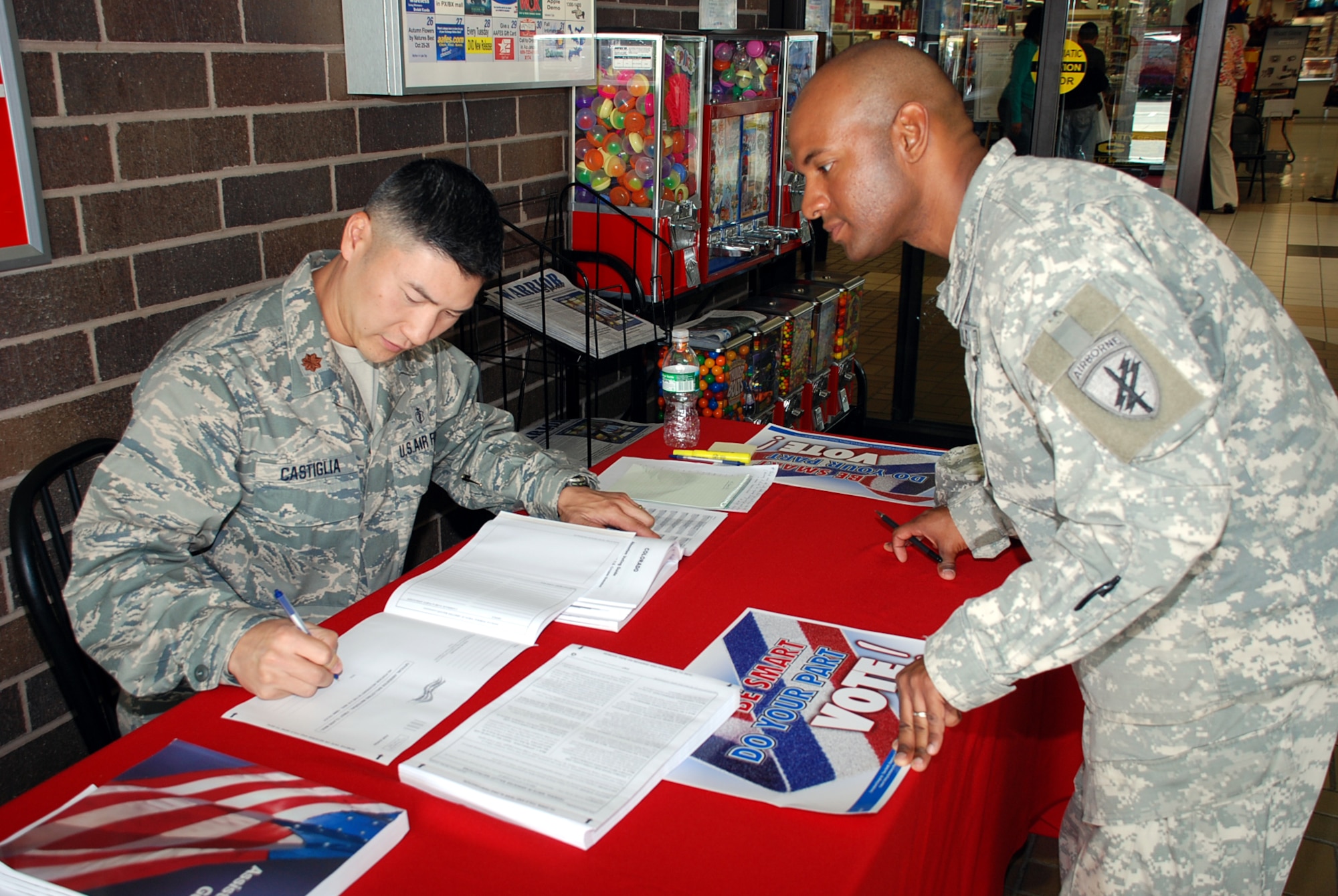 Left, Maj. Dan Castiglia, 305th Medical Group and installation voting assistance officer, helps Army Staff Sgt. Stephen Cook, 315th Psychological Operations Company, fill out his absentee ballot Oct. 15 at the BX. With only 20 days left until Election Day Nov. 4, Sergeant Cook, originally from Southern California, wanted to make sure his vote counted. For more information or to get an absentee ballot, contact your unit voting representative or call Major Castiglia at (609) 754-9468. 