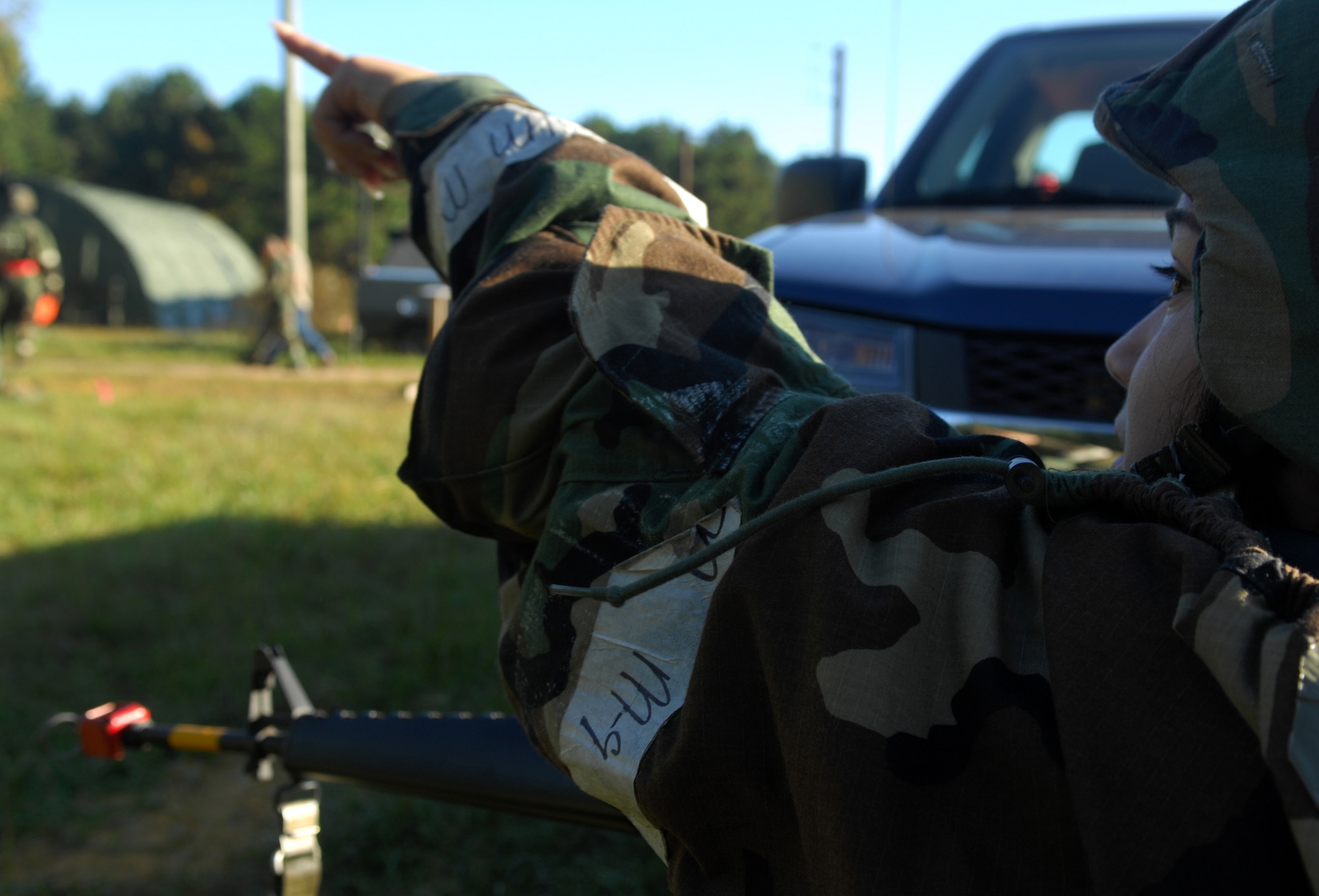 SHAW AIR FORCE BASE, S.C. -- Senior Airman Tania Darder, 20th Civil Engineer Squadron, takes cover behind a vehicle and calls out insurgent locations to other members of her team during a Phase II Operational Readiness Exercise Oct. 15. OREs help prepare and evaluate Airmen for real-world deployment. (U.S. Air Force photo/Staff. Sgt Patrick Mitchell)