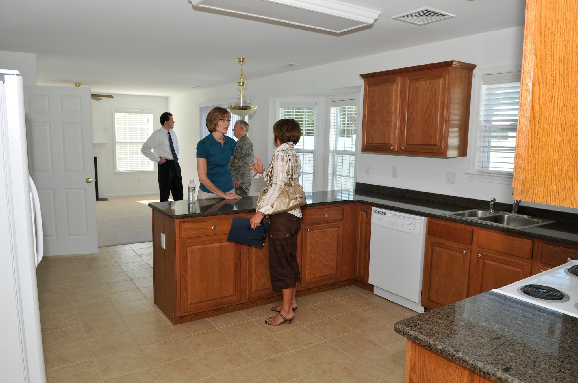 McGuire spouses discuss the new amenities that will be included in the new housing planned for the McGuire housing area. The tour was set up for officers’ spouses to have a chance to preview the new housing and be able to ask questions. (U.S. Air Force photo/Kenn Mann)