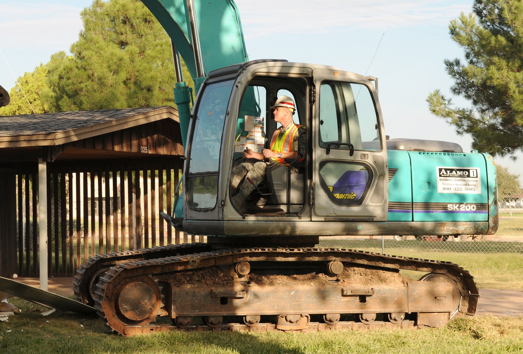DYESS AIR FORCE BASE, Texas -- Colonel Robert Gass, 7th Bomb Wing commander, operates wrecking equipment during the demolition of the previously designated wing commanders house here, Oct. 10.  This house is one of the last of the old base houses to be demolished.  Dyess AFB has replaced the old housing units with new homes to meet new standards and improve quality of life for our Airmen.  (U.S. Air Force photo/Staff Sergeant Darcie Ibidapo)