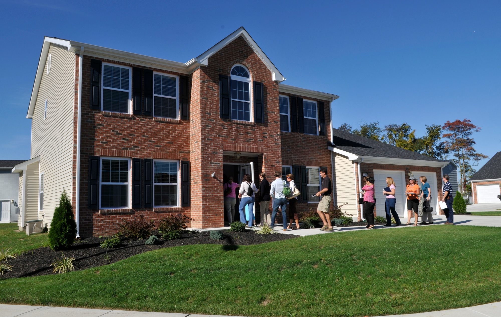 McGuire spouses head into the newly-constructed chief’s housing in the Starlifter housing area Oct. 10. Ms. Kristin Ayyar, wife of Col. Balan Ayyar, 305th Air Mobility Wing commander, set up the tour for officers’ spouses to view the new base housing and have a chance to ask questions to the United Communities staff. (U.S. Air Force photo/Kenn Mann)