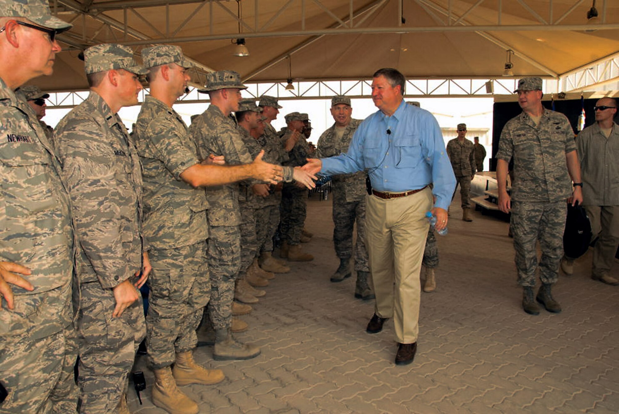 Secretary of the Air Force Michael B. Donley shakes the hands of several Airmen from the 380th Air Expeditionary Wing at an air base in Southwest Asia Oct. 12. The secretary visited the 380th Air Expeditionary Wing to gain a better understanding of the infrastructure and capabilities of one the smallest but most diverse bases in the Air Forces Central area of responsibility. (U.S. Air Force photo/Tech. Sgt. Denise Johnson)