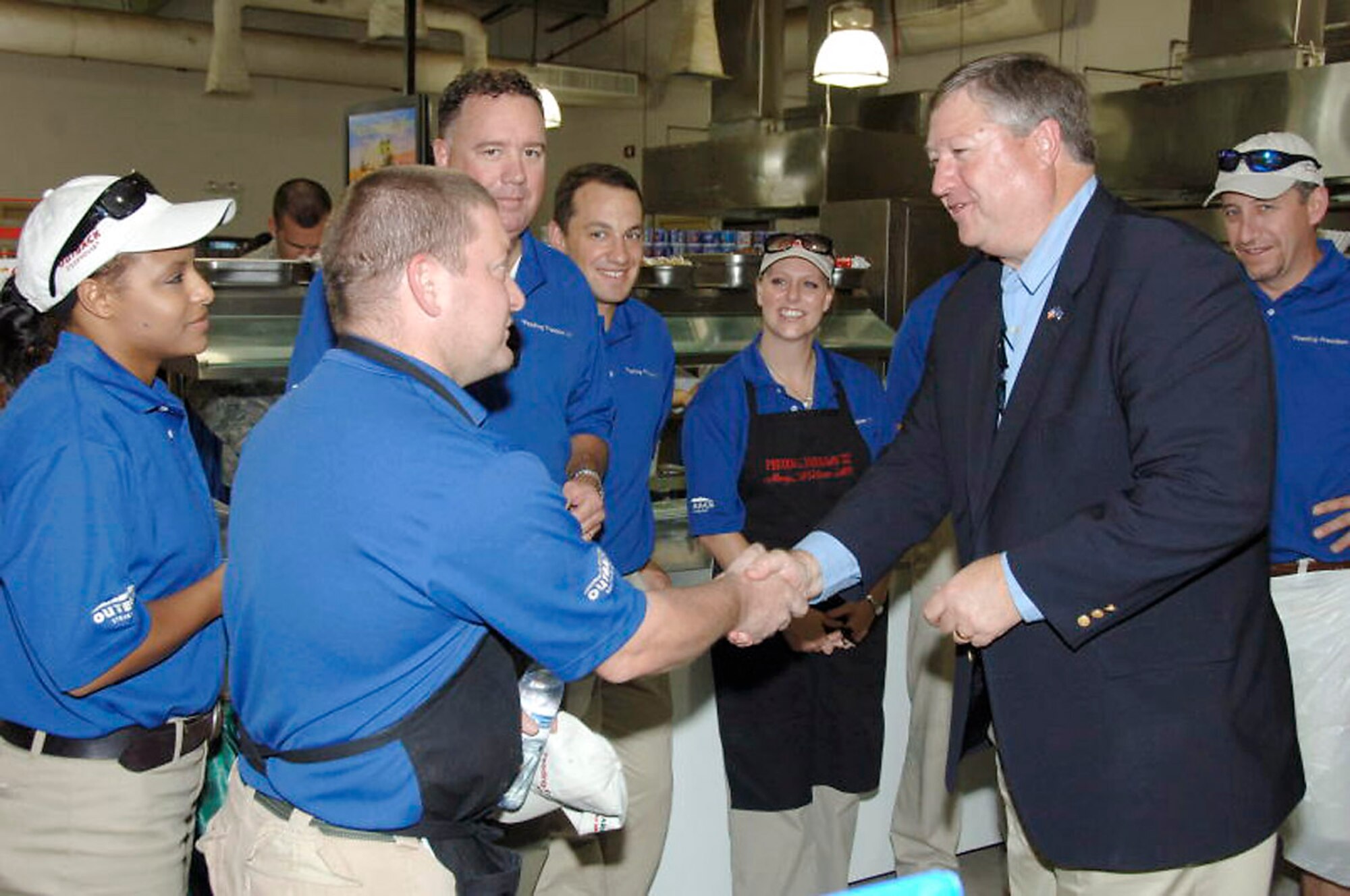 Secretary of the Air Force Michael B. Donley expressed his gratitude to members of Outback Steakhouse at an air base in Southwest Asia Oct. 12. Volunteers from Outback Steakhouse visited several bases in Southwest Asia to bring a little taste of home to the deployed troops to thank them for their service. The secretary told the volunteers how much it means to the troops to have great support from home while deployed so far away from loved ones. (U.S. Air Force photo/Tech. Sgt. Christopher A. Campbell)