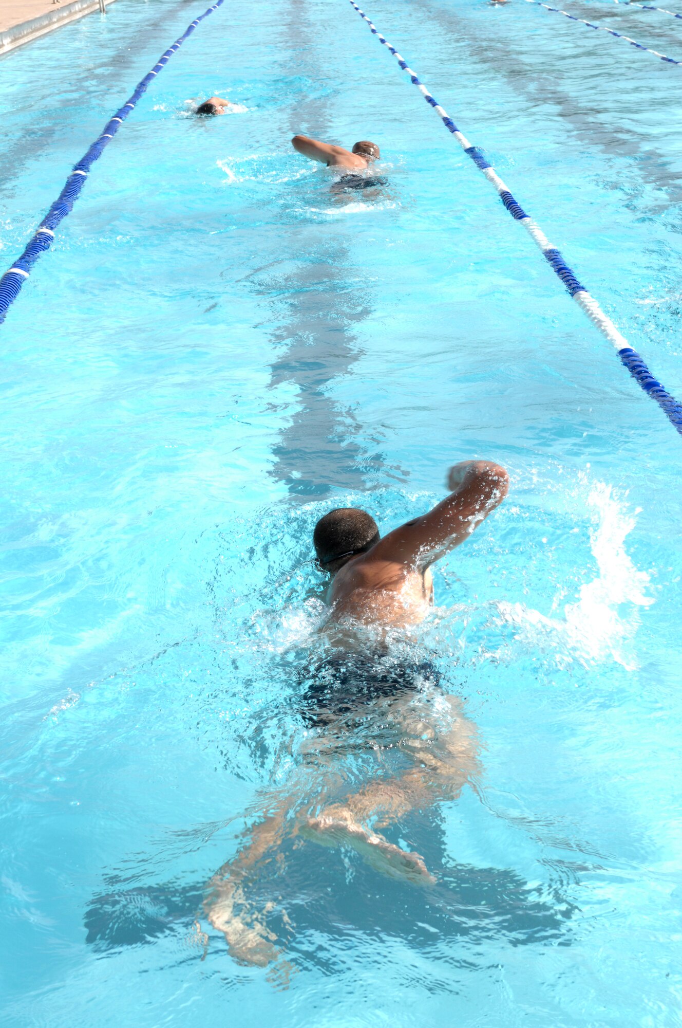 Athletes swim 700 meters in the Aquatic Center pool before completing the annual Triathlon at Holloman Air Force Base, N.M., October 21. The Triathlon was open to everyone who signed up and more than 60 athletes participated.  (U.S. Air Force photo/Airman Sondra M. Escutia)