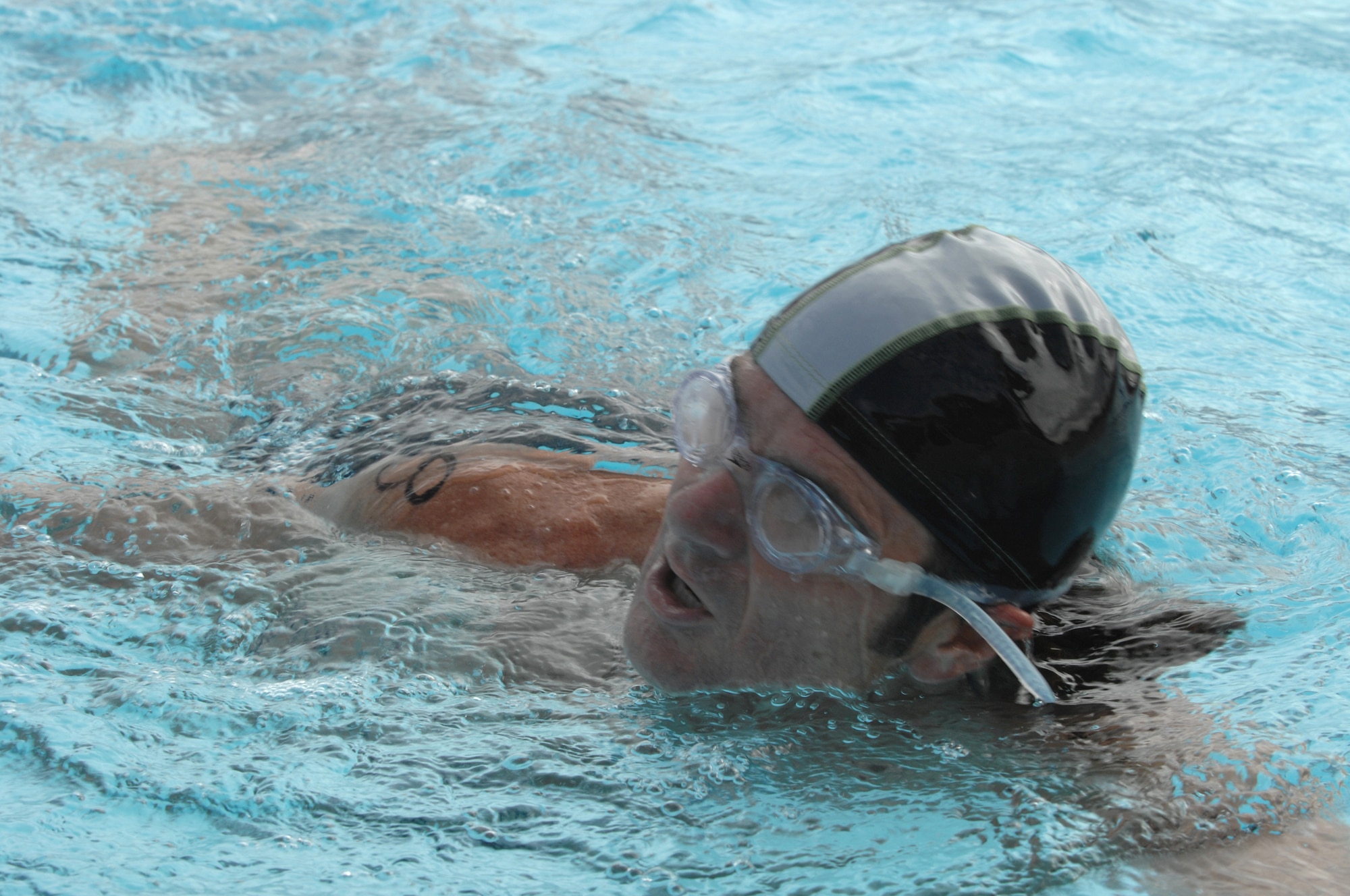 Boris Valdevit, an athlete in the Triathlon, swims 700 meters after running 5K and bicycling 30K in the annual Triathlon at Holloman Air Force Base, N.M., October 21. Mr. Valdevit came in third place, missing second place by a minute, with a time of one hour and 38 minutes. (U.S. Air Force photo/Airman Sondra M. Escutia)