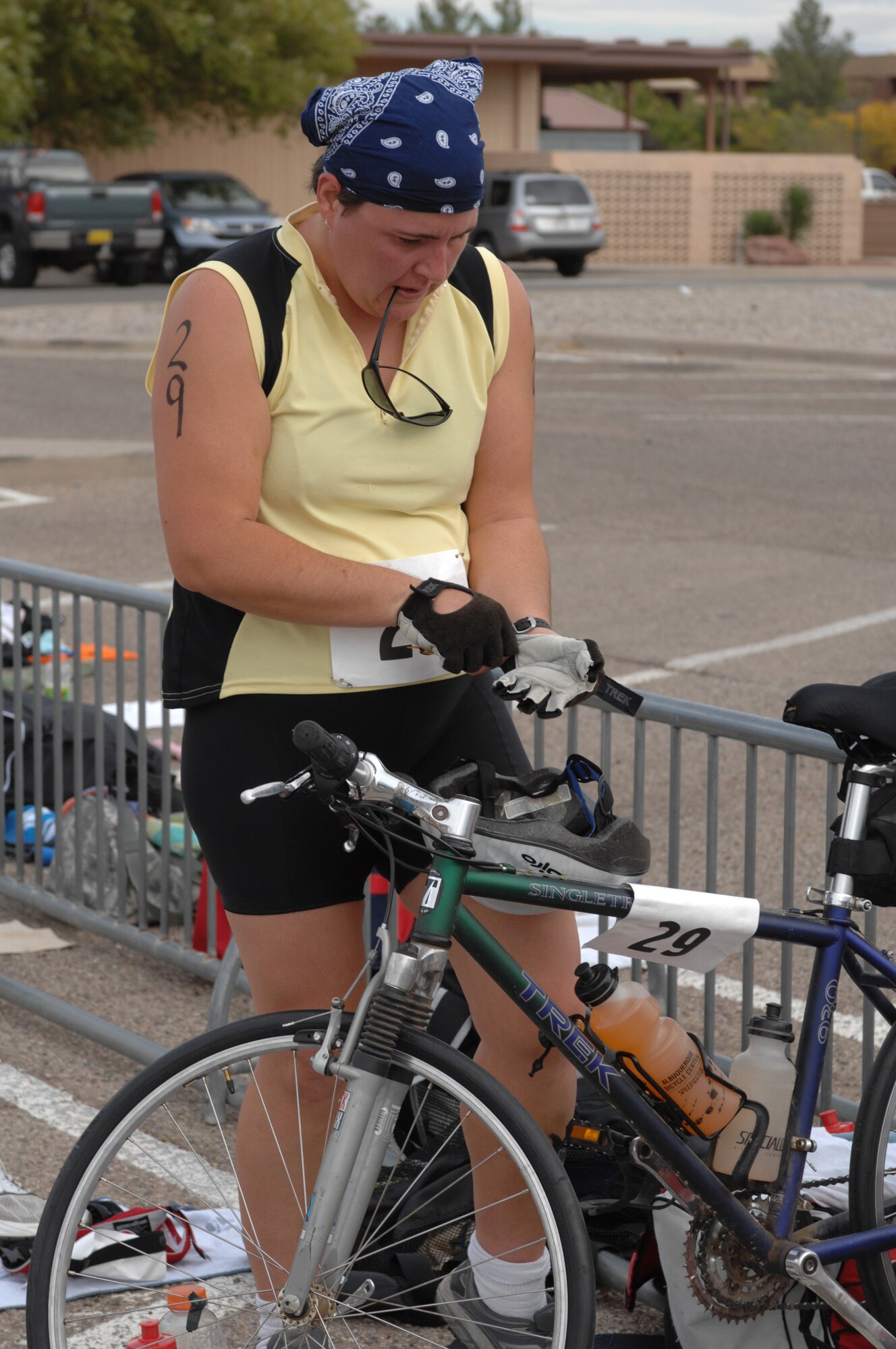 Alexandria Sanchez, an athlete in the Triathlon, puts on her gloves after finishing a 5K run and prepares for the 30K bike ride at the Aquatic Center at Holloman Air Force Base, N.M., October 12. The annual Triathlon was open to everyone who signed up and more than 60 athletes participated. (U.S. Air Force photo/Airman Sondra M. Escutia)