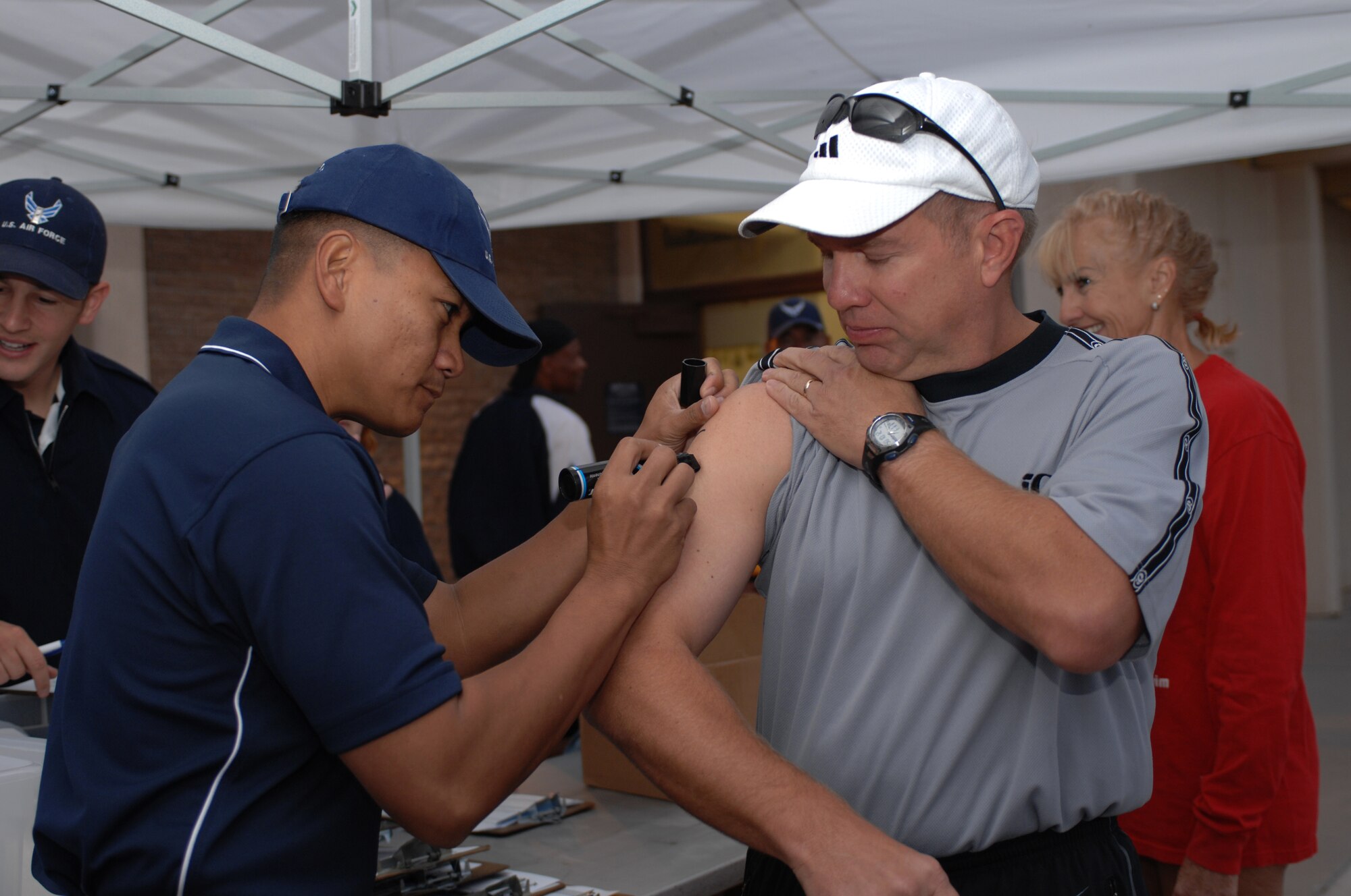 Master Sgt. Reynaldo Bautista, 49th Force Support Squadron, writes Lt. Col. Keith Vraa?s race number on his arm before the Triathlon at Holloman Air Force Base, N.M., October 12. The annual Triathlon was open to everyone who signed up and more than 60 athletes participated. (U.S. Air Force photo/Airman Sondra M. Escutia)