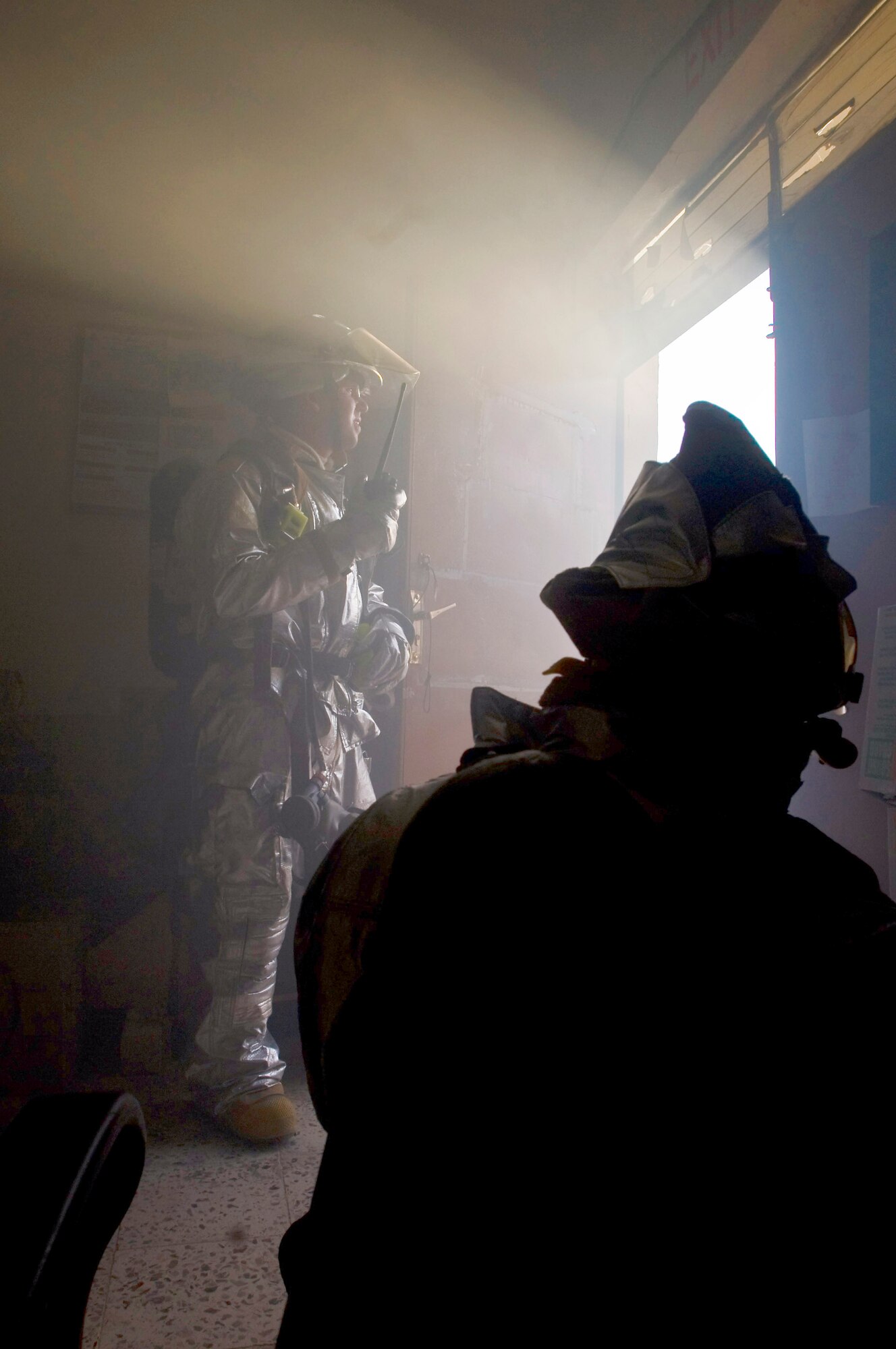 Tech. Sgt. Garrick Hasty opens a door to clear smoke from a room during a structural firefighting drill Oct. 3 at Ali Base, Iraq. Sergeant Hasty, a firefighter with the 407th Expeditionary Civil Engineer Squadron, is deployed from Vandenberg Air Force Base, Calif. (U.S. Air Force photo/Airman 1st Class Christopher Griffin) 
