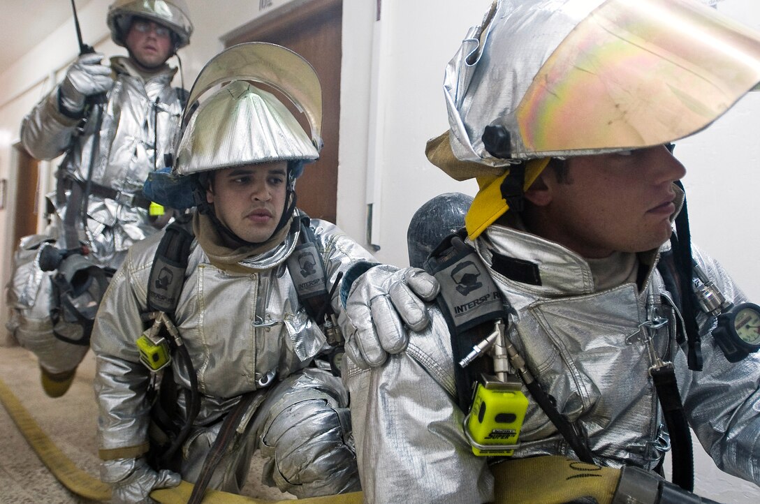 Tech. Sgt. Garrick Hasty, Airman 1st Class Gregory Ramirez and Senior Airman Nathan Sole prepare to enter a smoke-filled room during a structural firefighting drill Oct. 3 at Ali Base, Iraq. Sergeant Hasty is deployed from Vandenberg Air Force Base, Calif., Airman Ramirez is deployed from Columbus AFB, Miss., and Airman Sole is deployed from the Minnesota Air National Guard's 133rd Airlift Wing. (U.S. Air Force photo/Airman 1st Class Christopher Griffin) 
