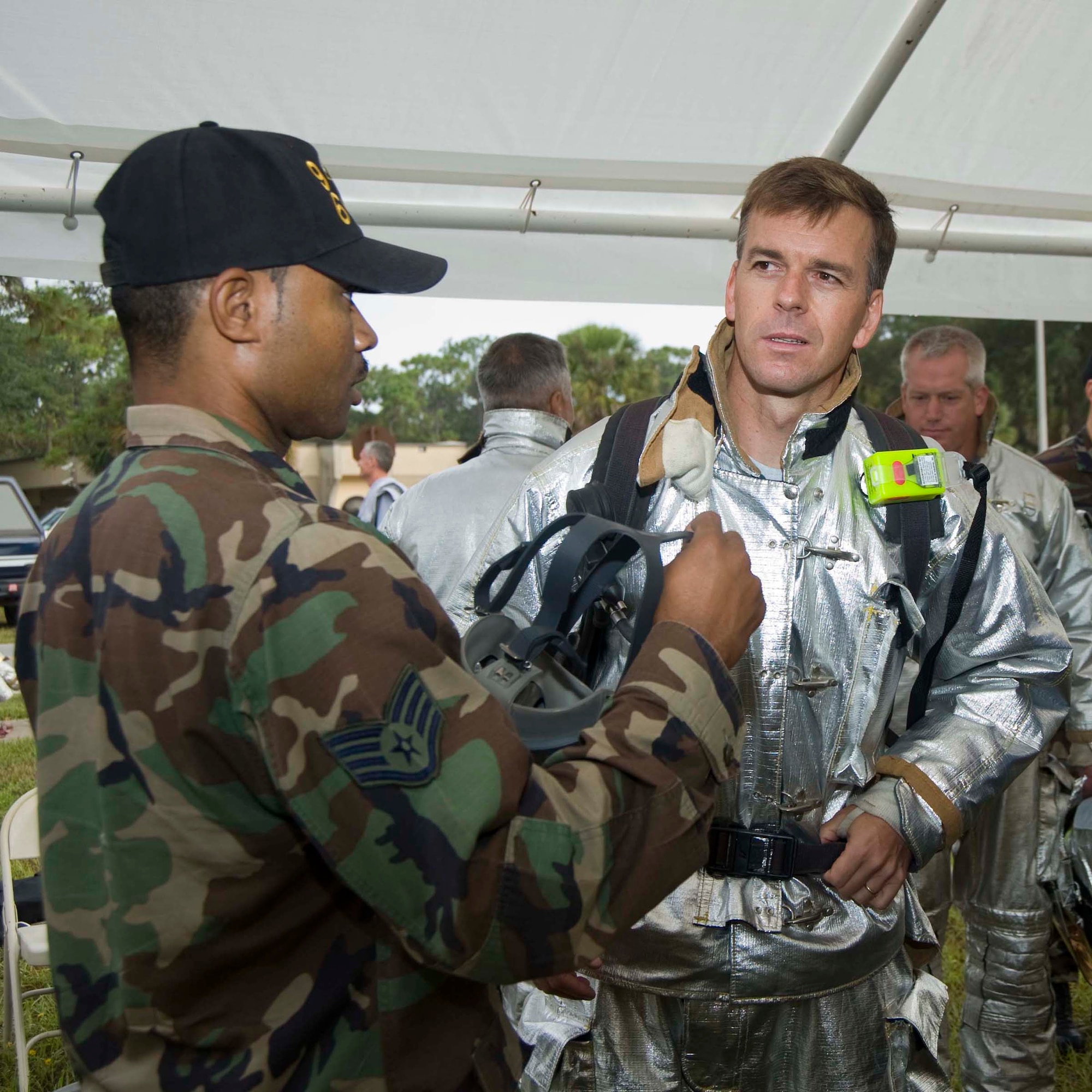 Col. Bruce McClintock, 96th Air Base Wing commander, listens to instructions from firefighter Staff Sgt. Aaron Farrow, before the Fire & Emergency Services Commanders Challenge Oct. 10.  Commanders rescued a "body" from a smoke filled house. The 96th Communications Group won the challenge with a record-setting time of 1 minute and 46 seconds. (USAF photo by Bruce Hoffman)

  