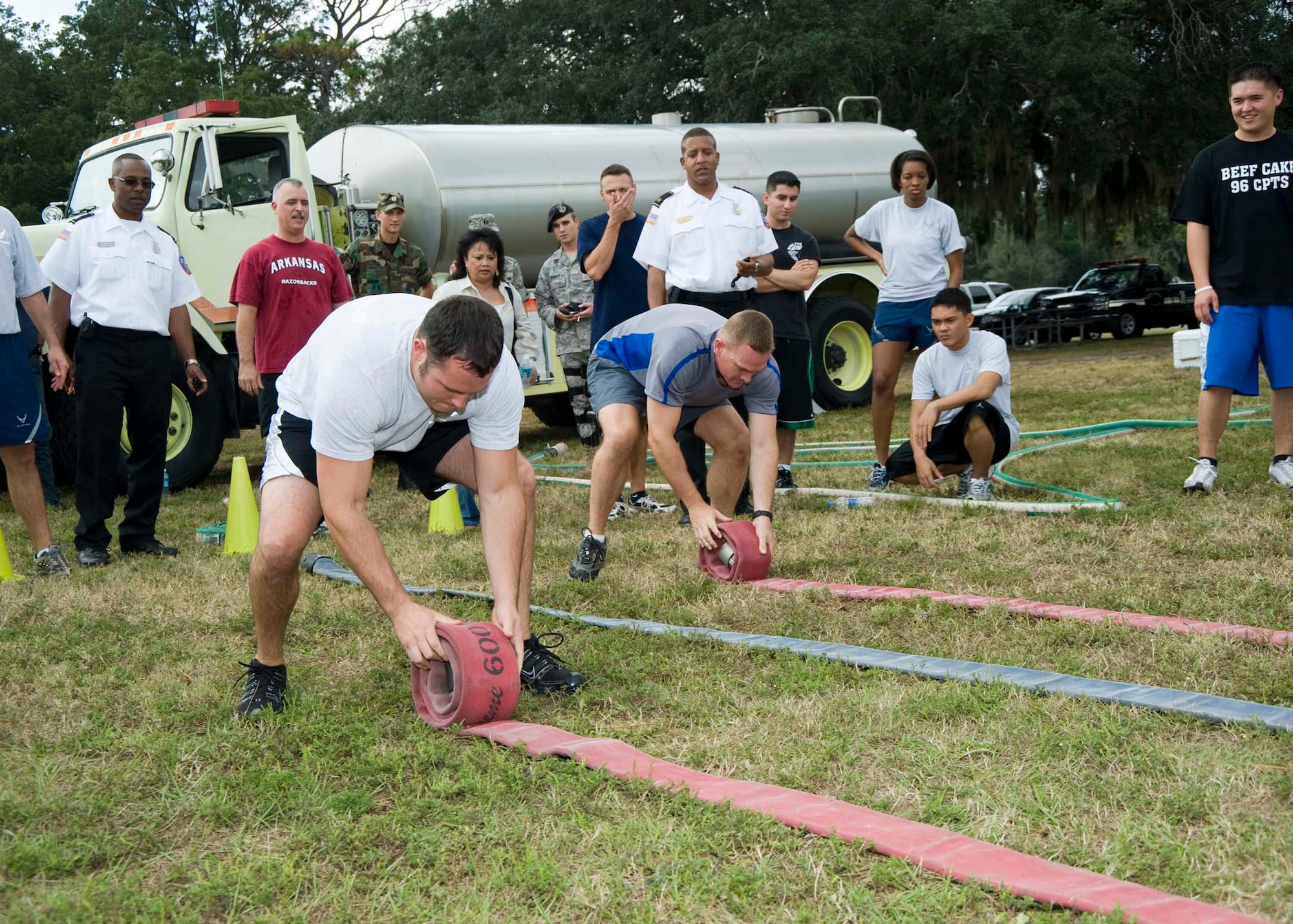 Teams compete in the fire hose roll during the Fire Muster competition at Weekly Pond Oct. 10. The events were the culmination of Fire Prevention Week.
